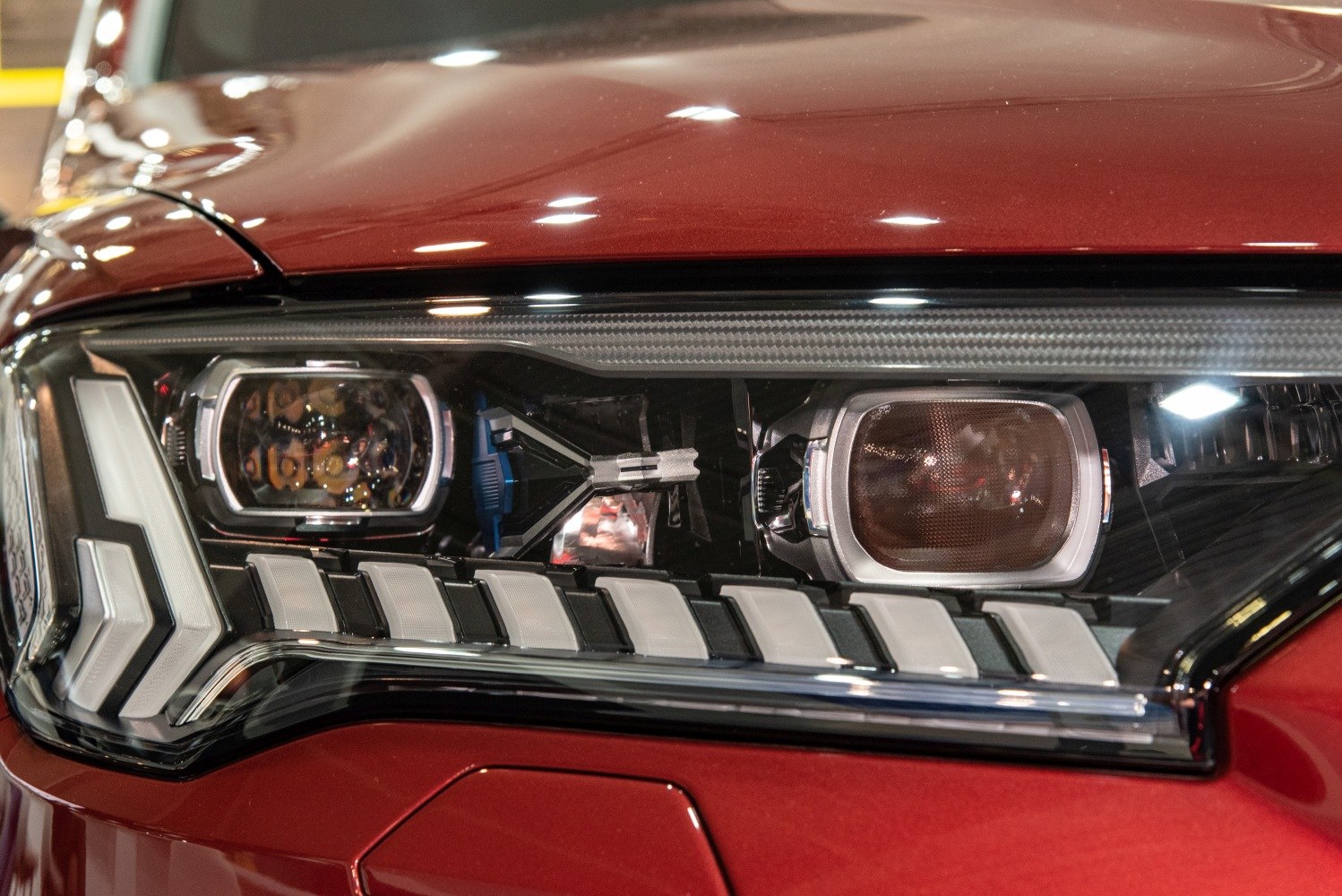 Close-up of detailed LED headlight assembly with intricate design and lighting elements.