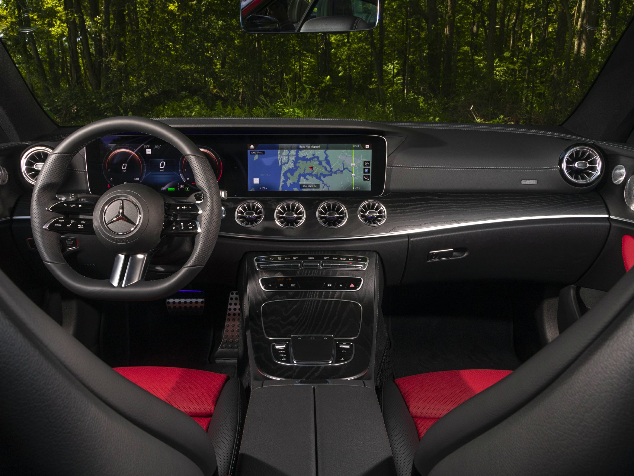 Digital dashboard, touchscreen display, and sporty steering wheel.