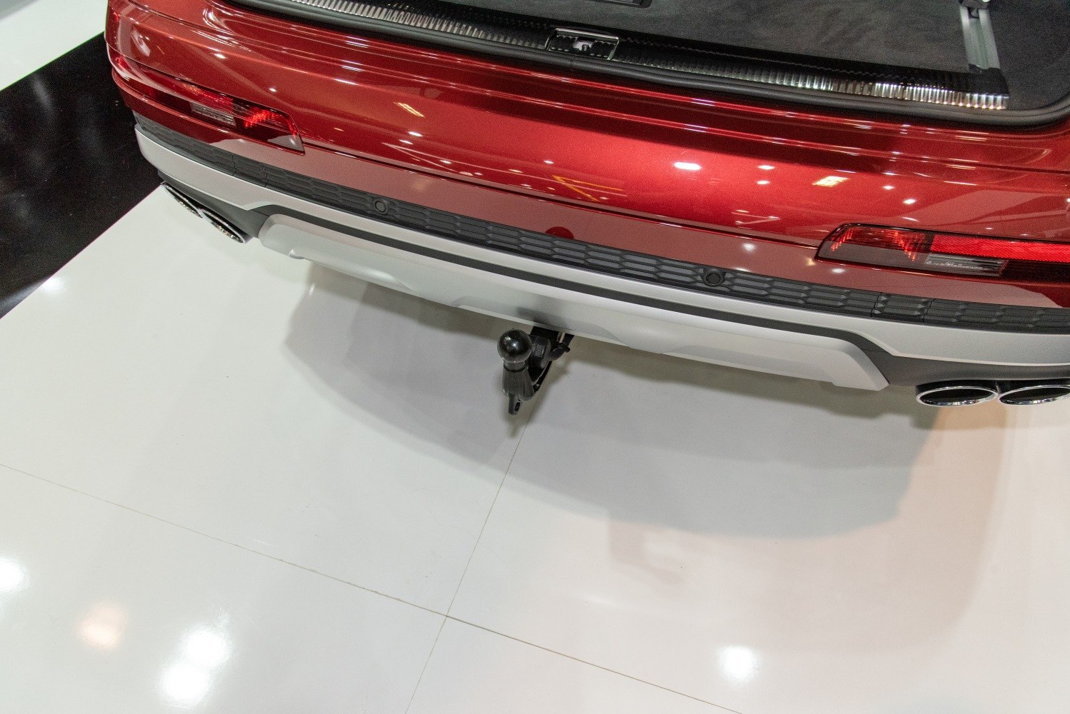 Rear bumper with tow hitch and quad exhaust pipes