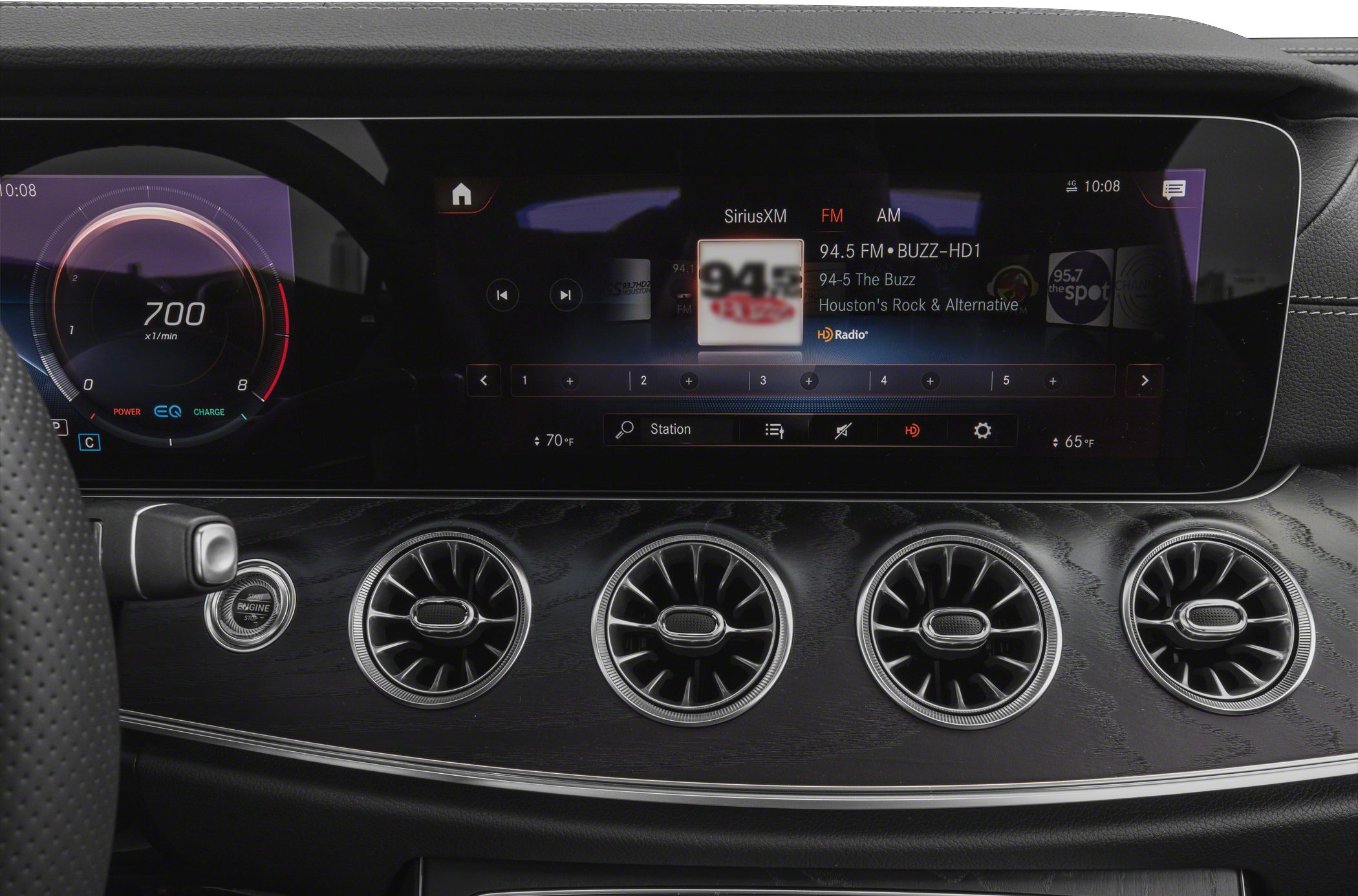 Digital speedometer and infotainment screen with four circular air vents
