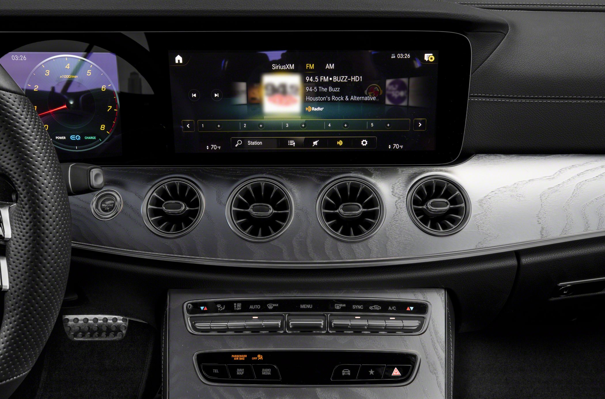 Modern digital dashboard with circular air vents and advanced infotainment controls