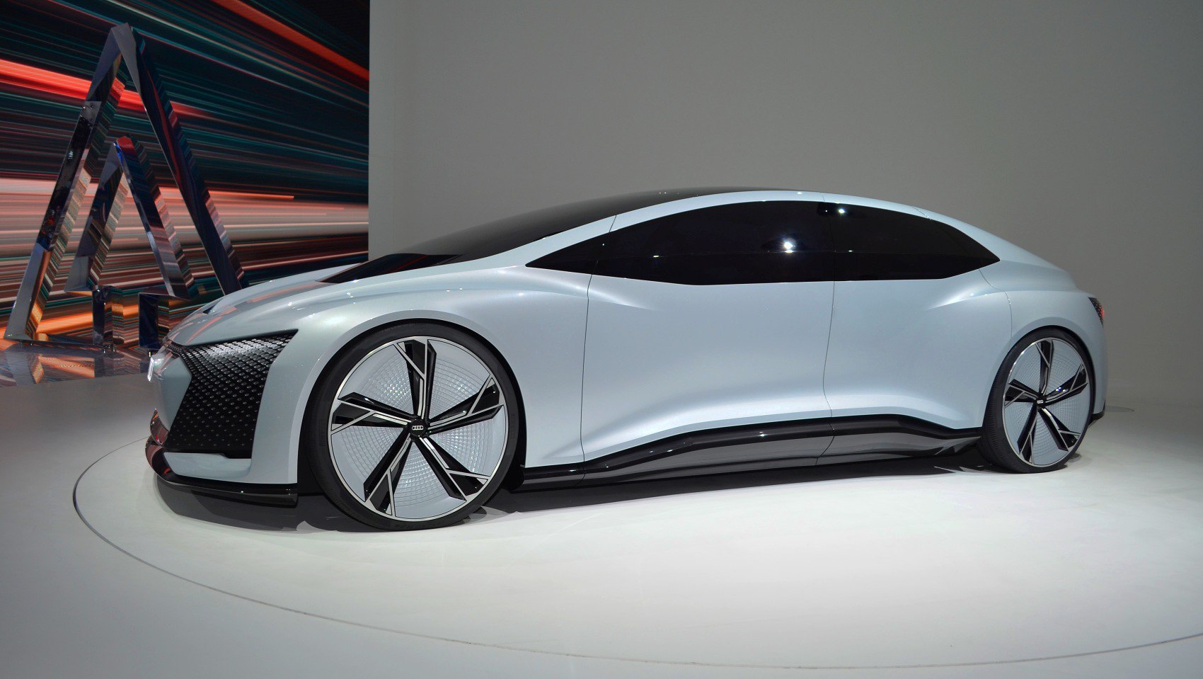 Futuristic electric sedan with aerodynamic design and large wheels