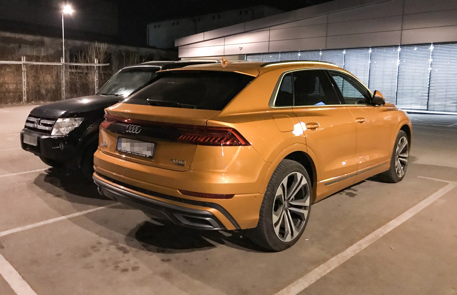 Rear view of SUV with LED strip tail lights and dual exhaust tips.