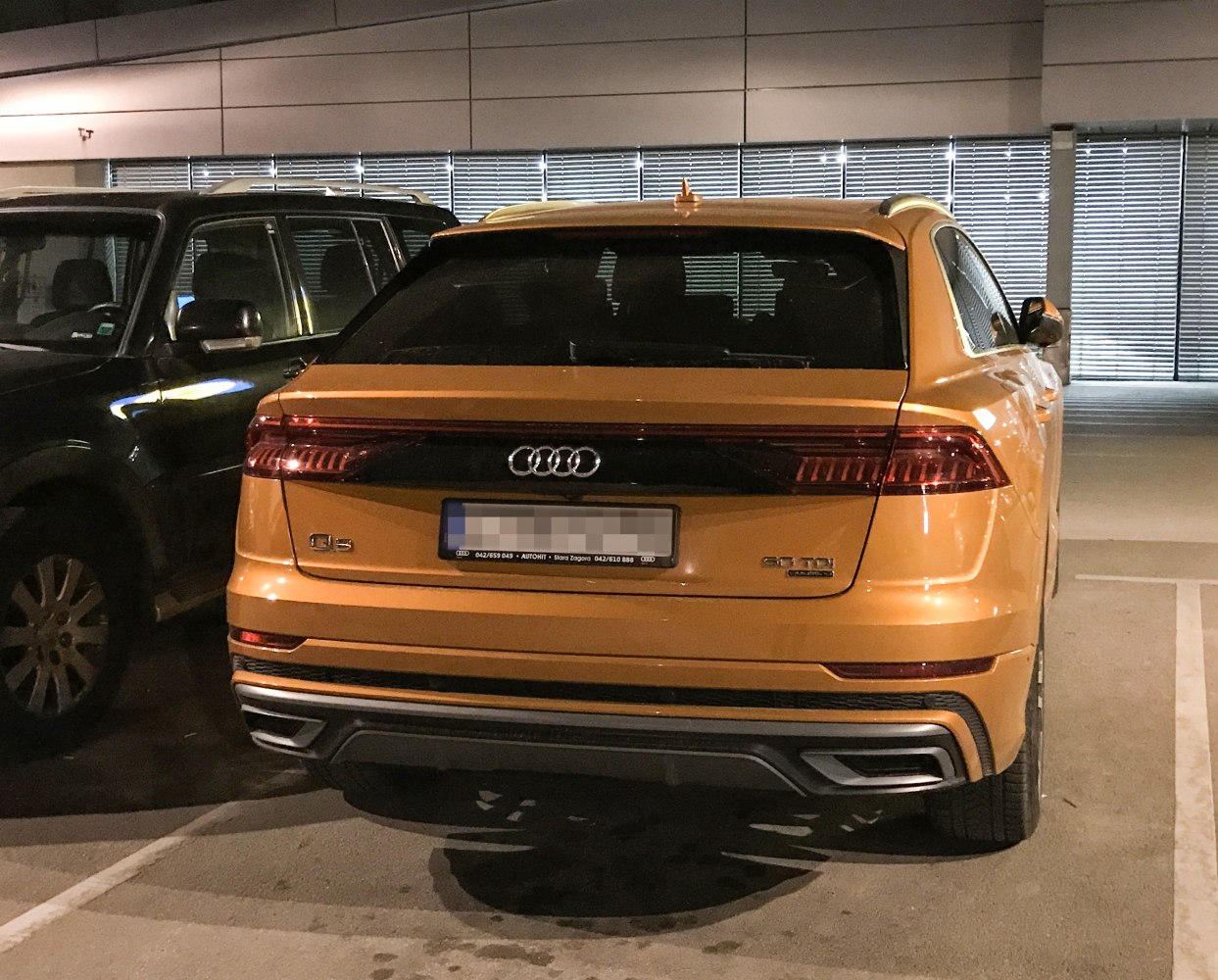 Yellow Audi SUV rear featuring distinctive tail lights and bumper