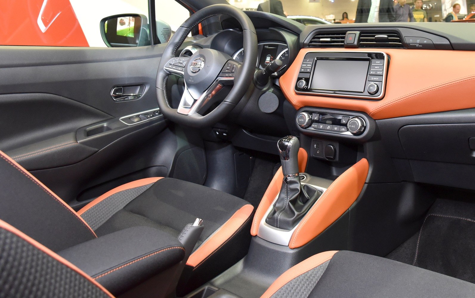 Manual gear shift, touchscreen display, modern dashboard with steering wheel controls