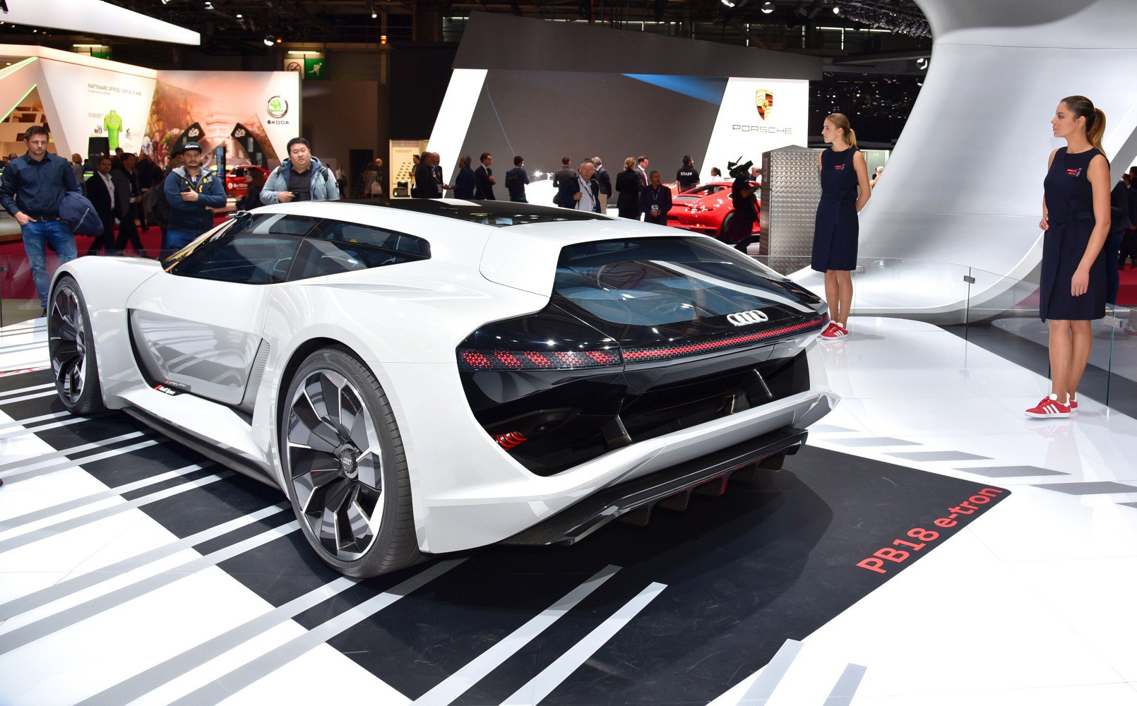 Rear view and futuristic wheel design of a sleek electric sports coupe.