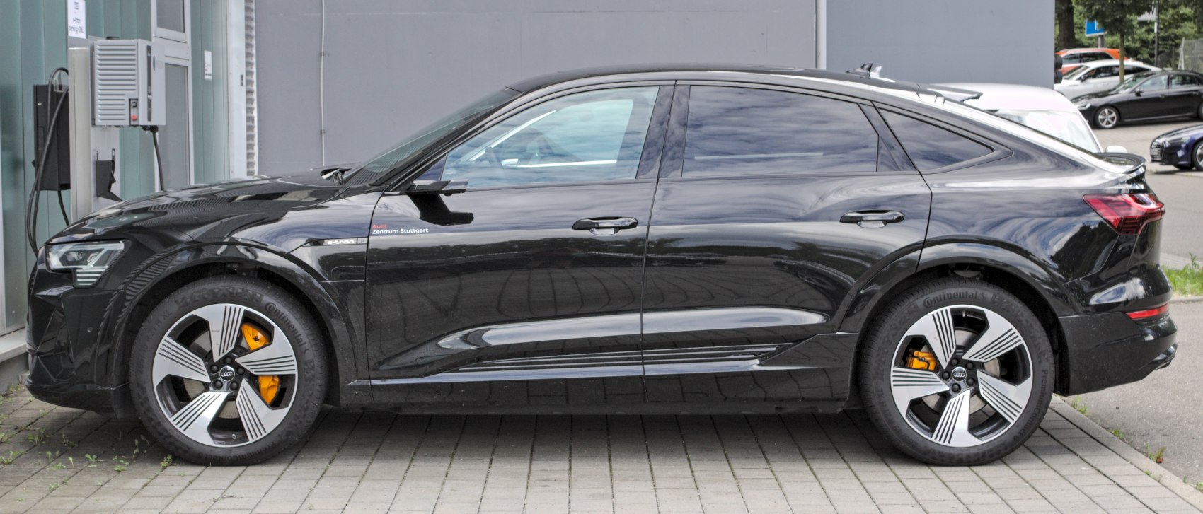 Side profile view of electric SUV with alloy wheels and orange brake calipers