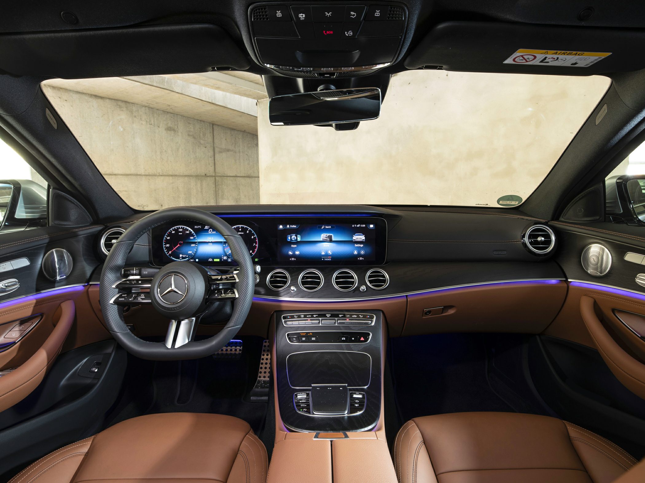 Digital dashboard and steering wheel with ambient lighting in luxury car interior