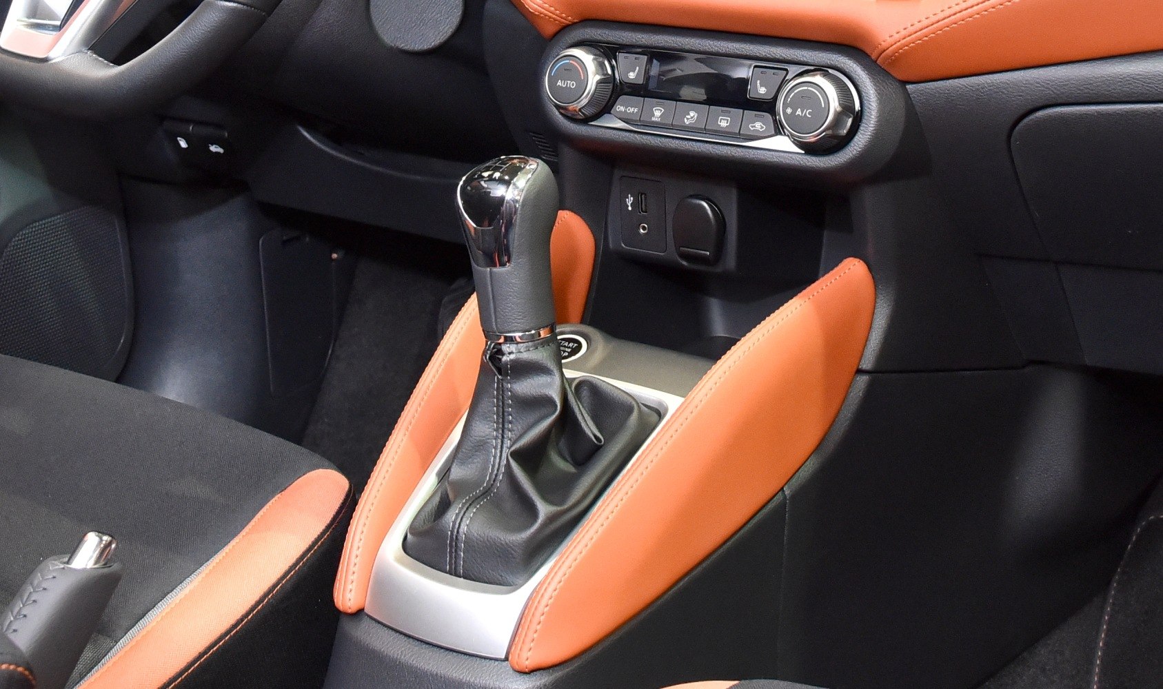 Gear shift lever with orange trim and climate control panel