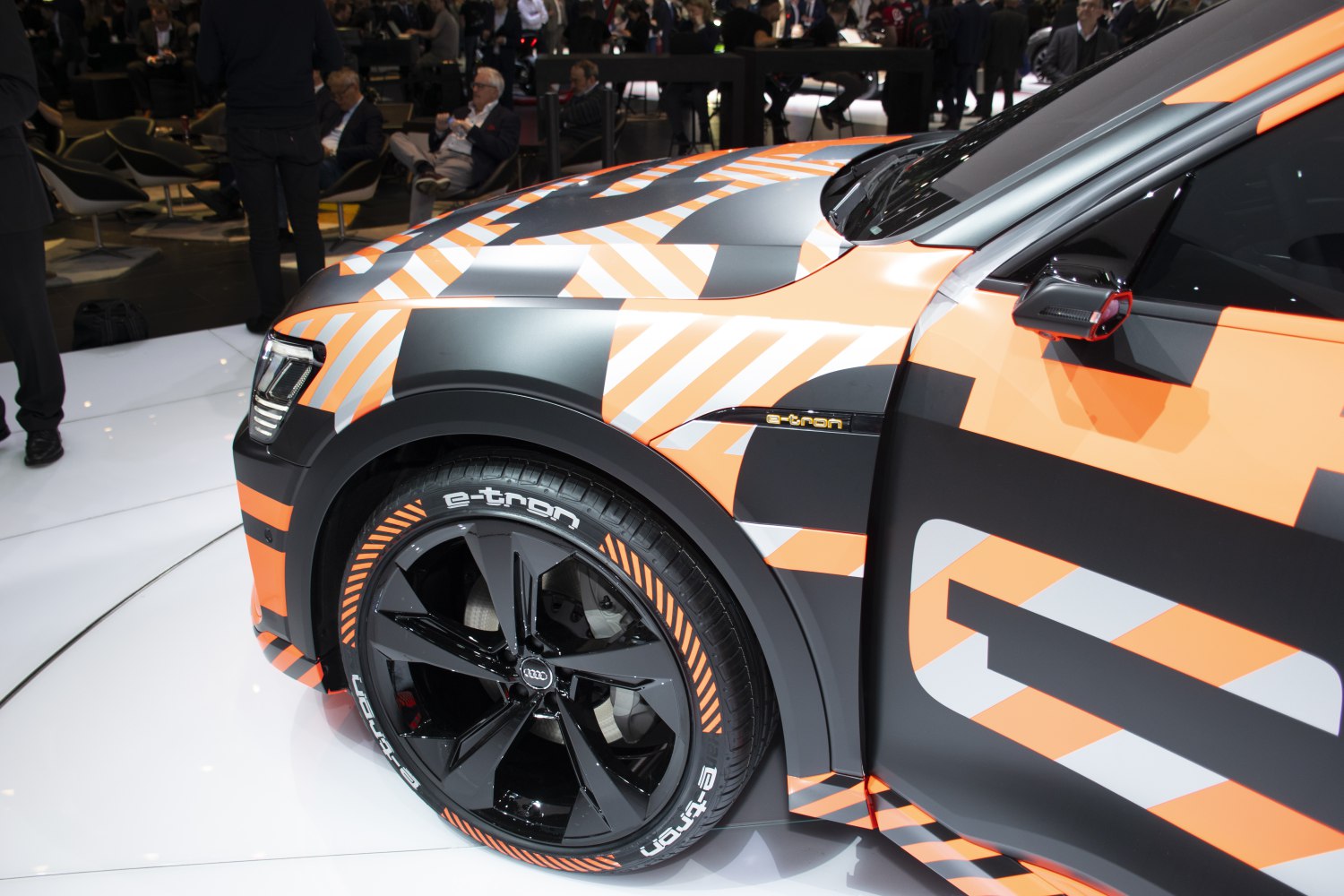 Front wheel and fender with orange-black camouflage wrap and black alloy wheel