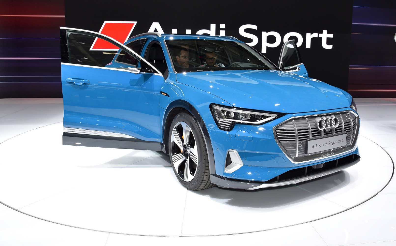 Electric SUV front view with open doors and alloy wheels