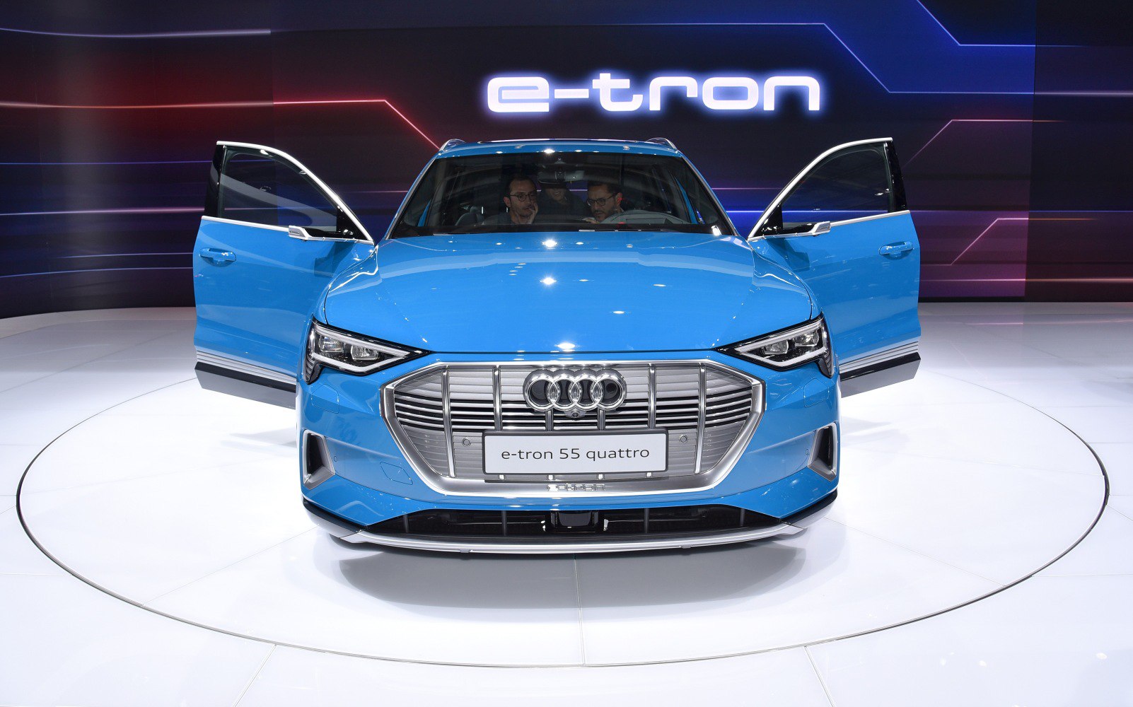 Front exterior view with LED headlights and open doors.