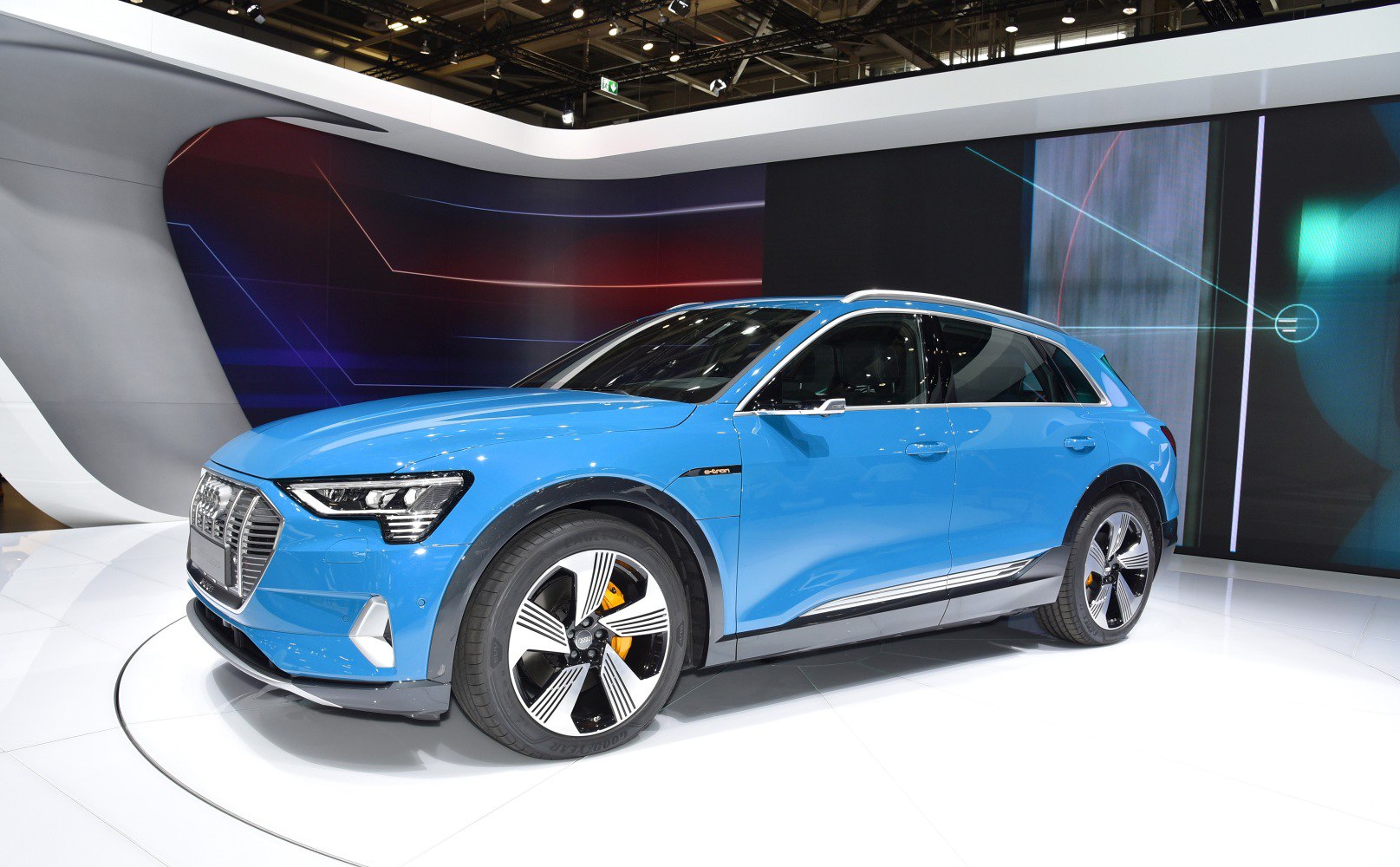 Front and side view of a blue electric SUV with LED headlights and aerodynamic wheels