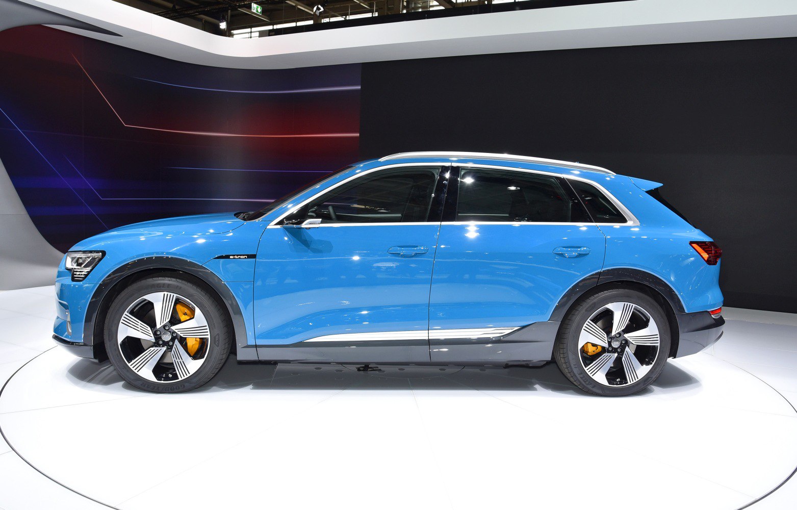 Electric SUV side profile with alloy wheels and orange brake calipers