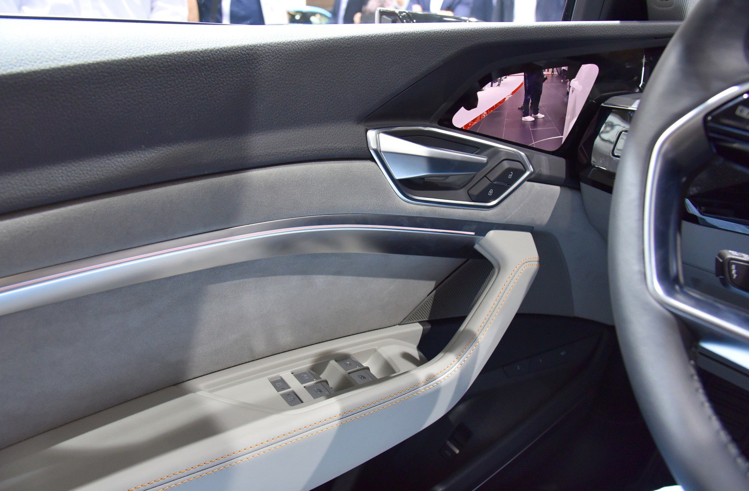 Audi car interior door panel with control buttons and sleek handle