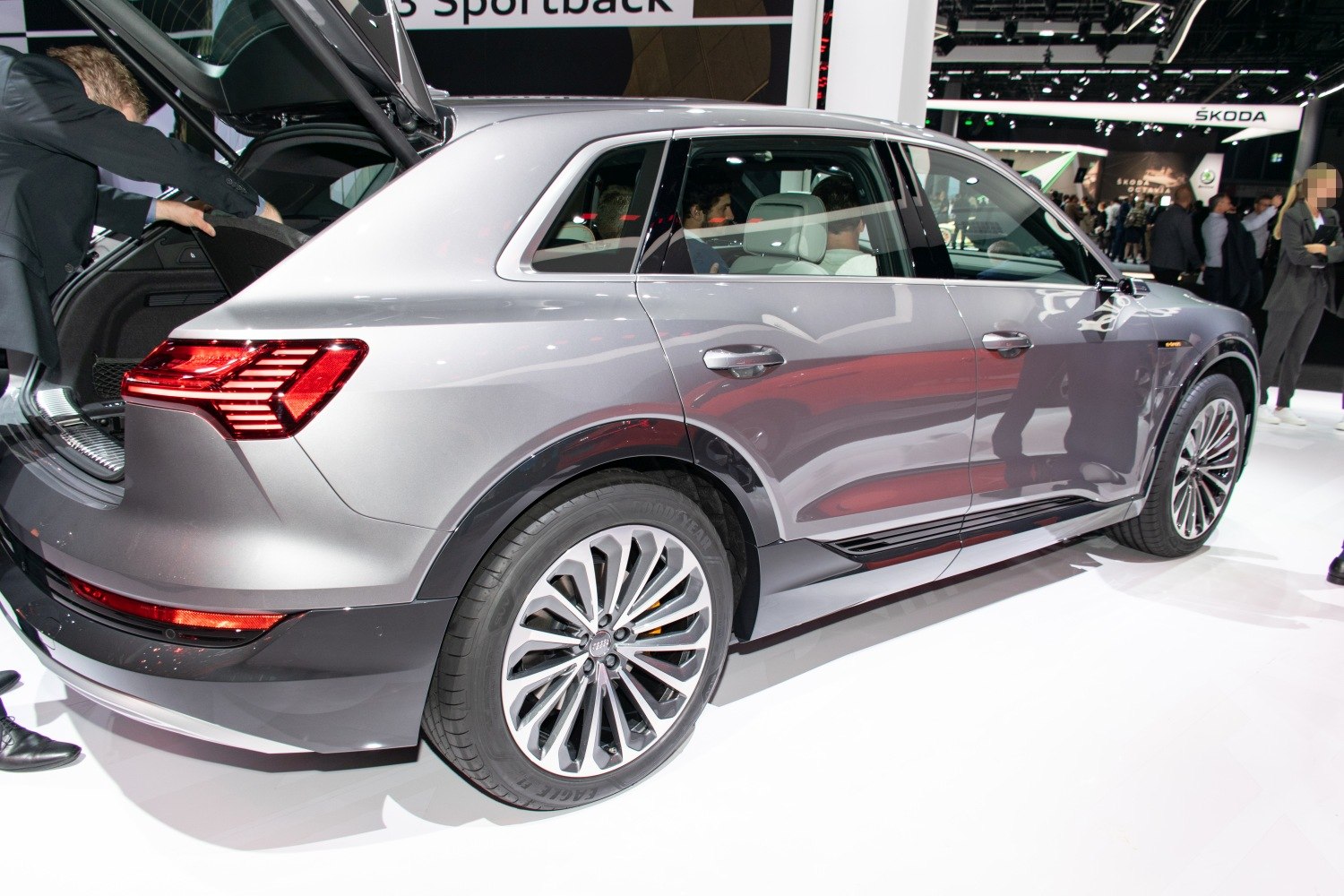 Rear side view of electric SUV with open trunk and alloy wheel