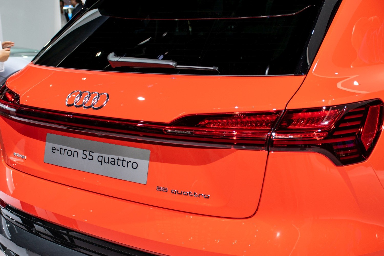 Close-up of modern LED rear light and badges on electric SUV rear.