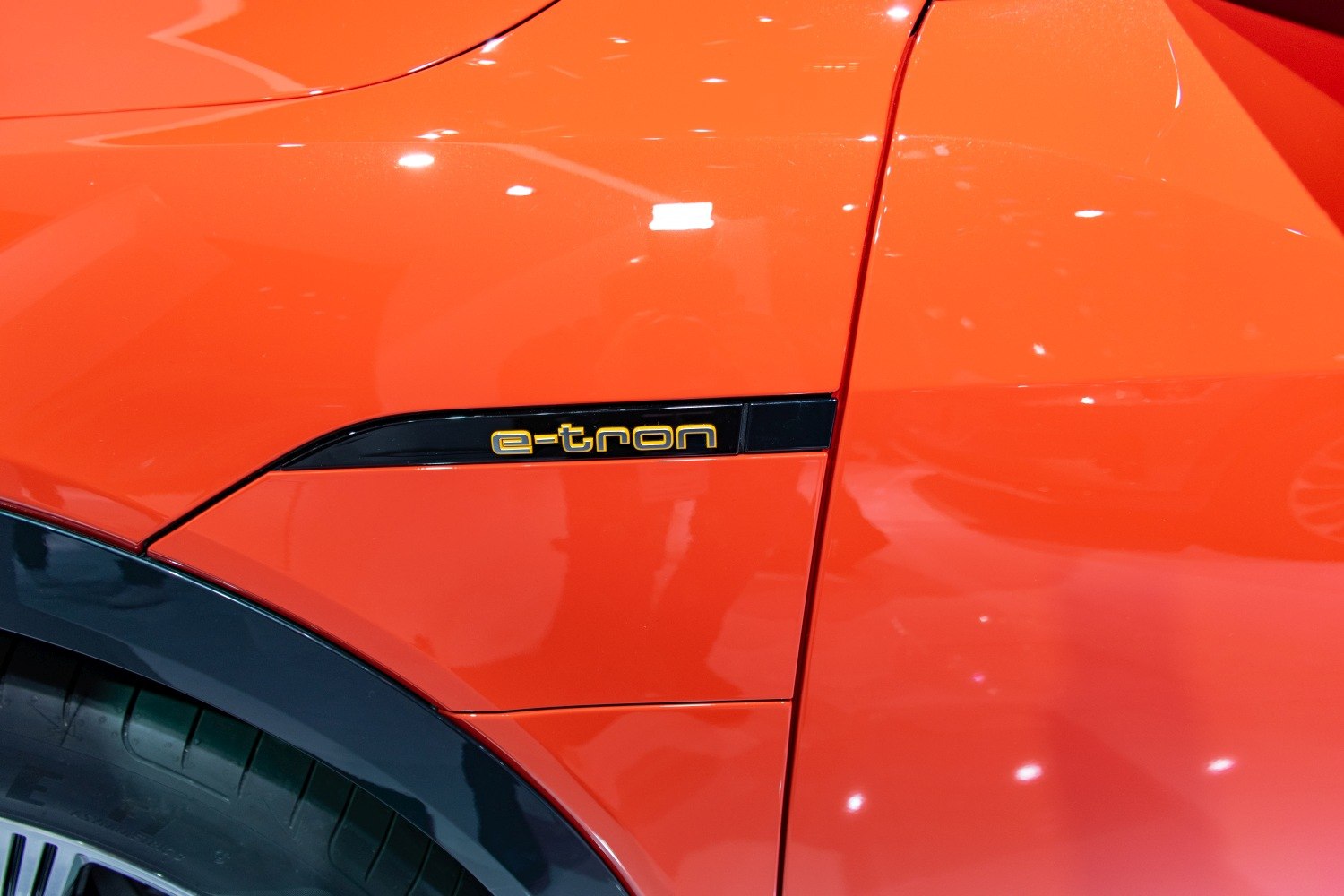 Close-up of e-tron badge on orange fender panel