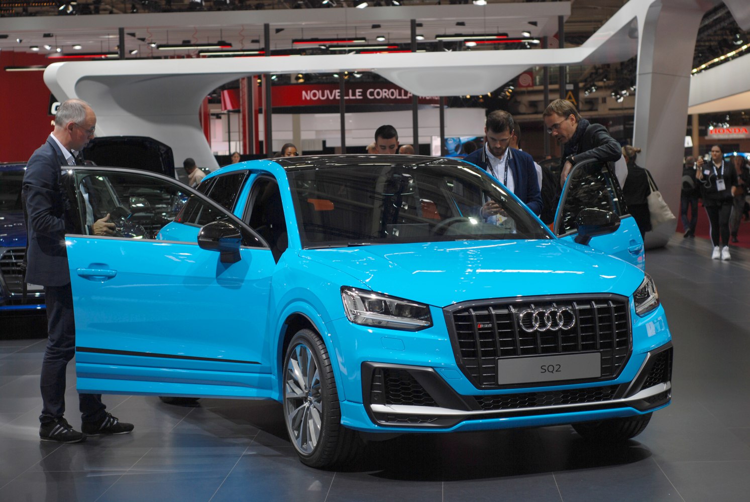 Bright blue hatchback with distinctive front grille and open doors