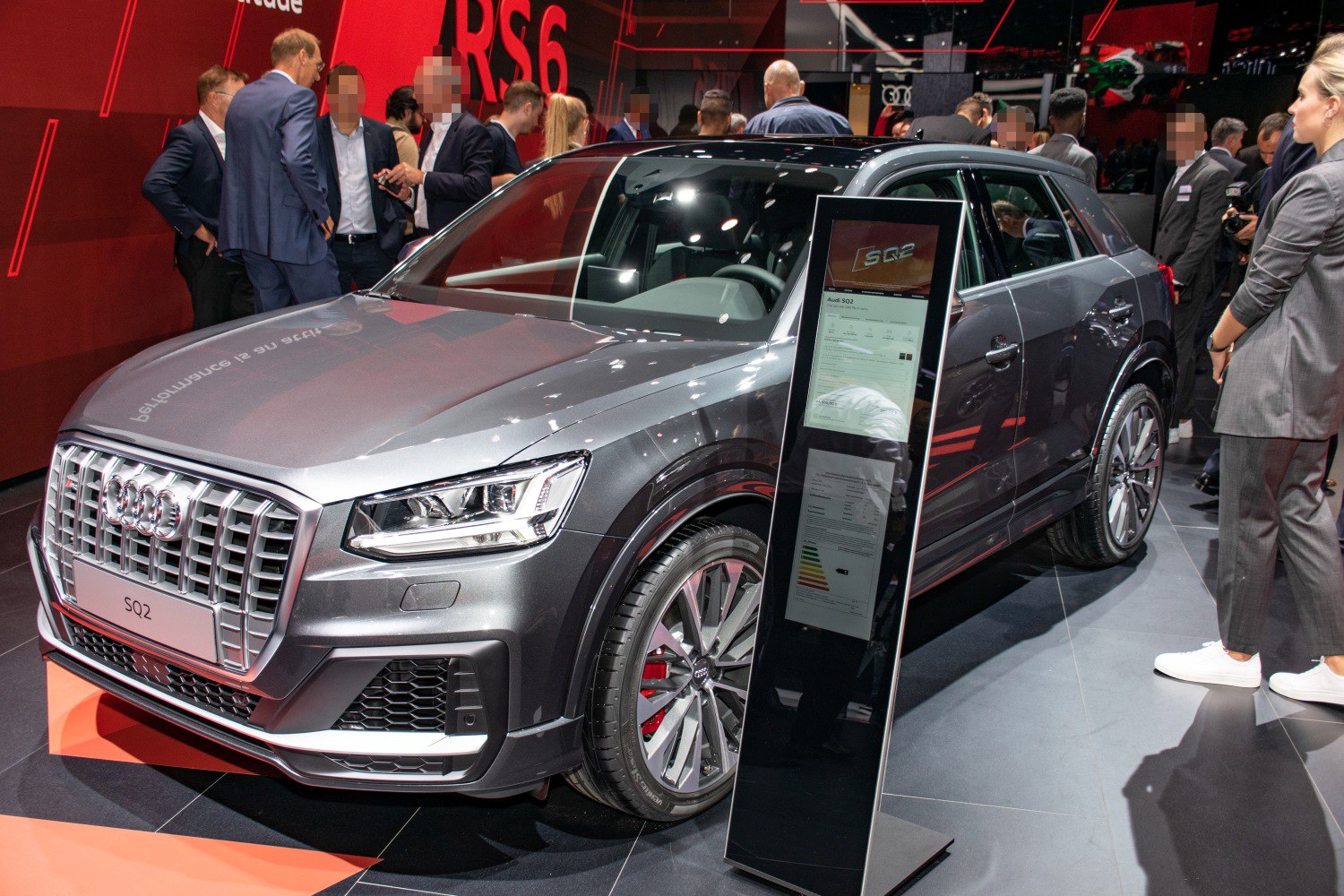 Front and side view of SUV with prominent grille and sporty wheels