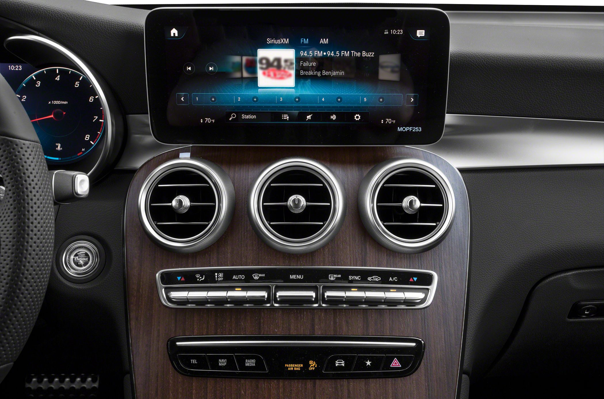 Central touchscreen infotainment system with three circular air vents and climate control panel