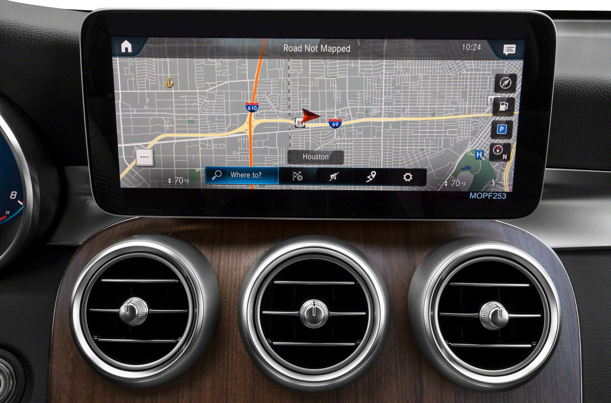 Digital navigation display with three circular air vents on wood-trim dashboard