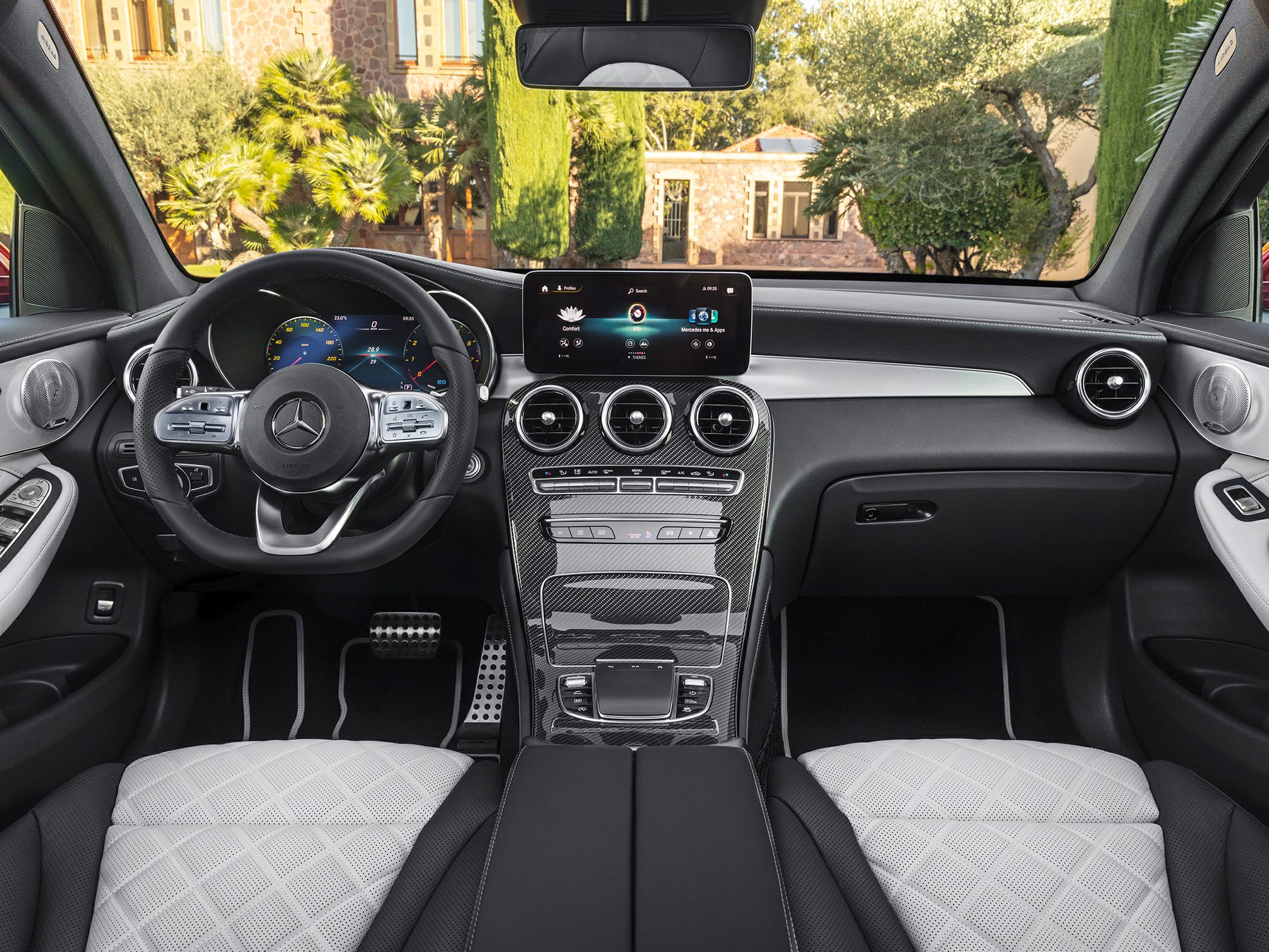 Modern digital dashboard and carbon fiber center console trim with quilted seats