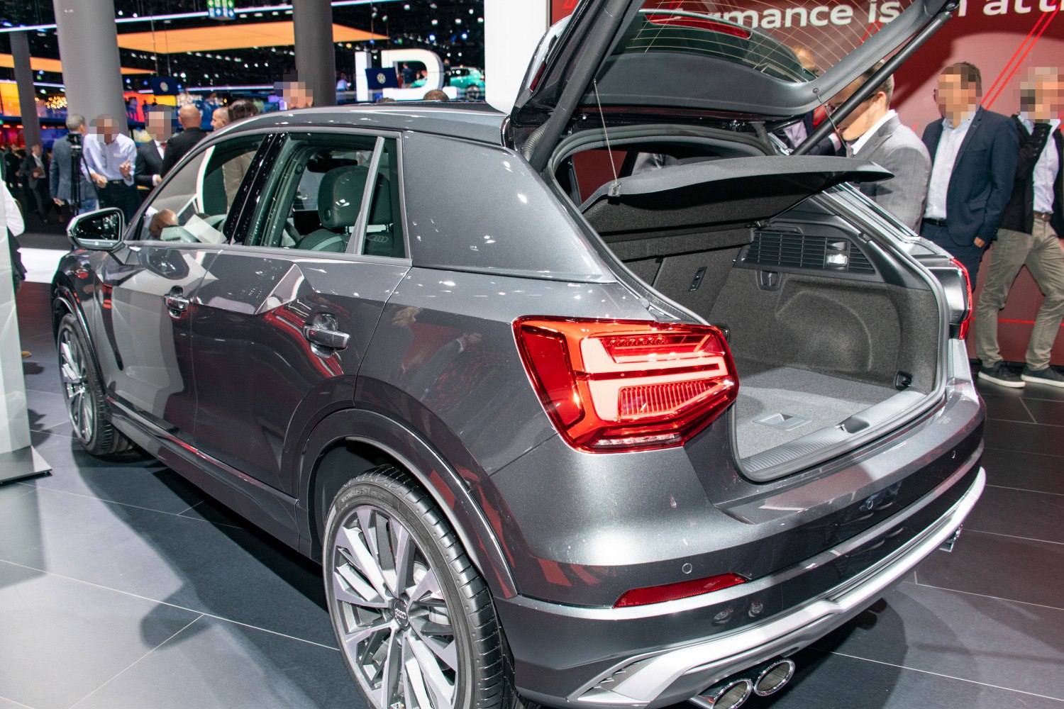 Rear view of SUV with open trunk and visible taillights, alloy wheels.