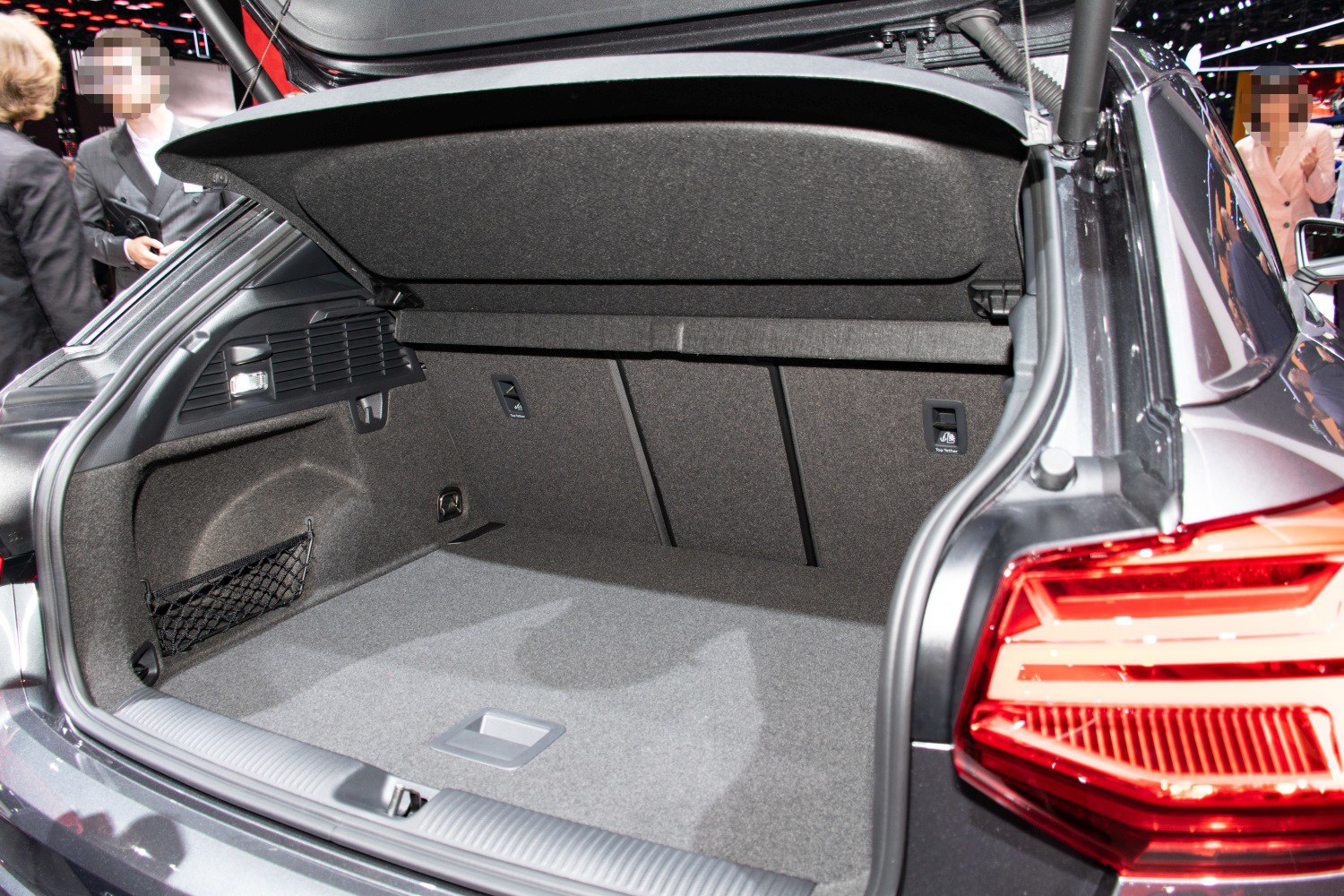 Spacious car trunk interior with storage net and foldable rear seatbacks