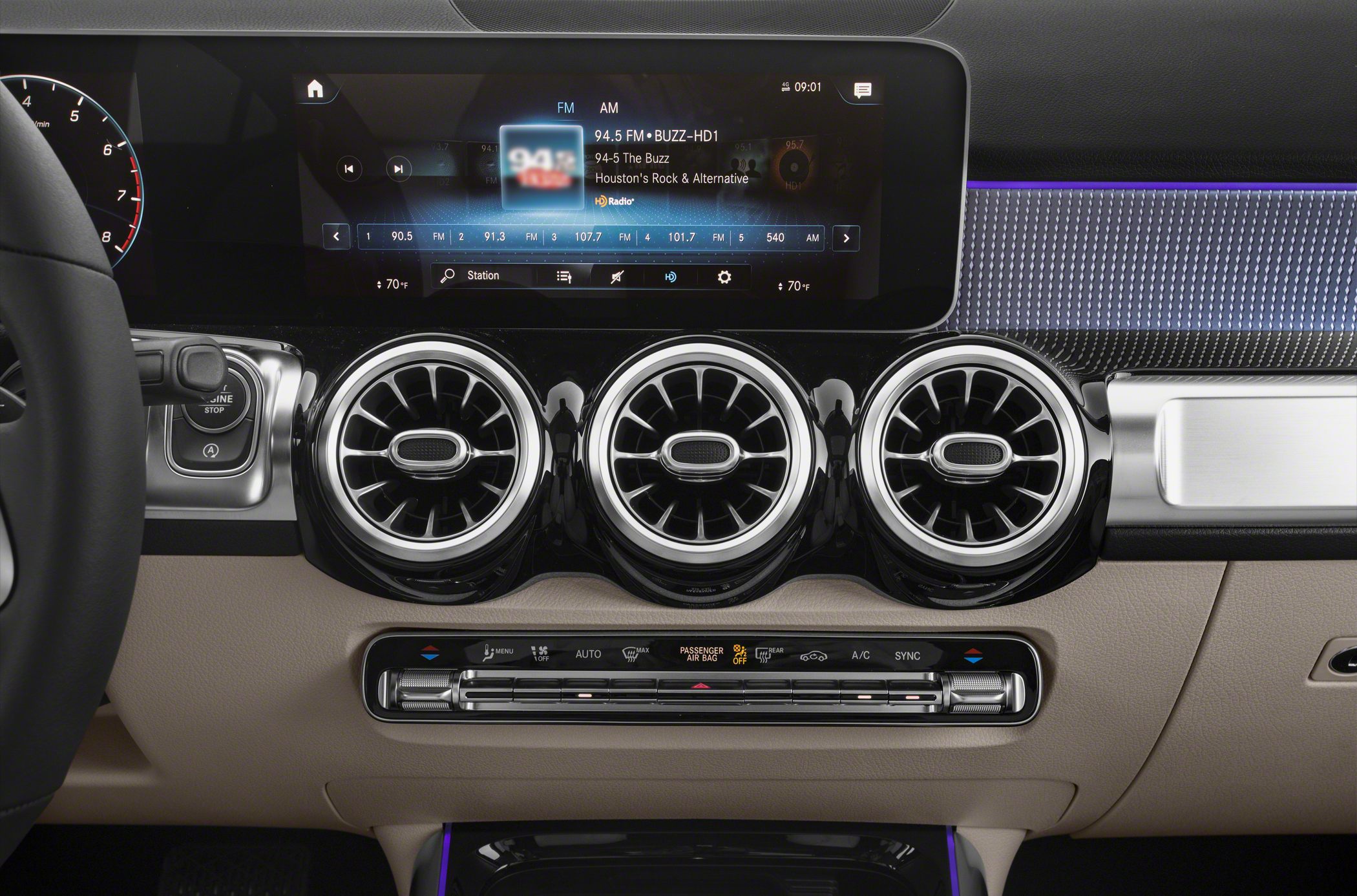 Digital infotainment display and three circular air vents on dashboard