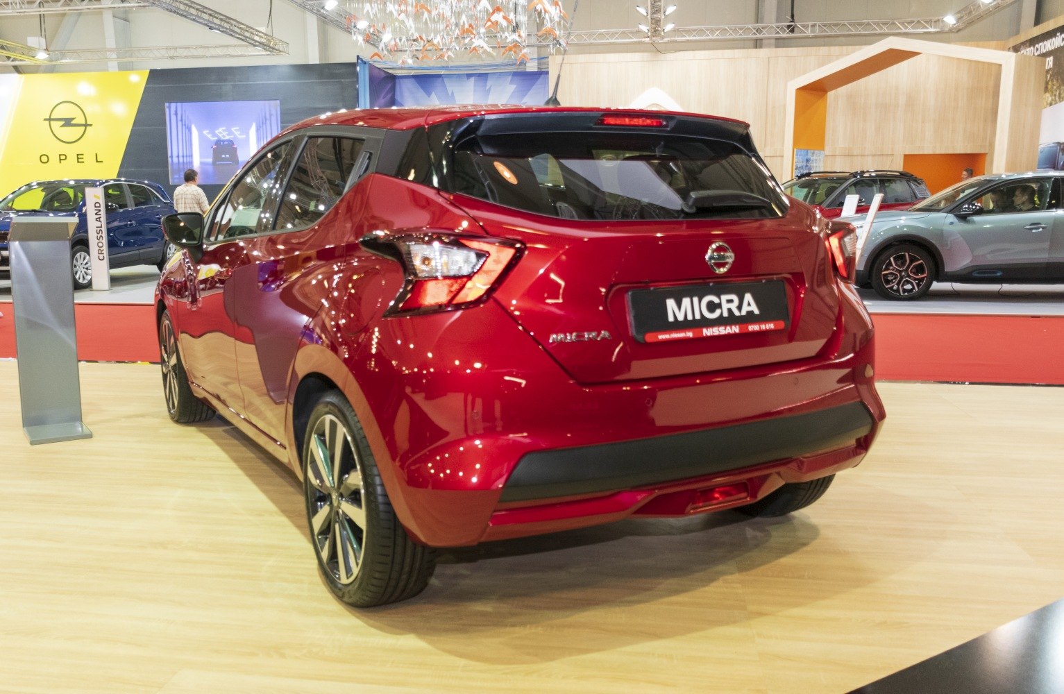Red hatchback rear view with distinctive angular taillights and black roof spoiler