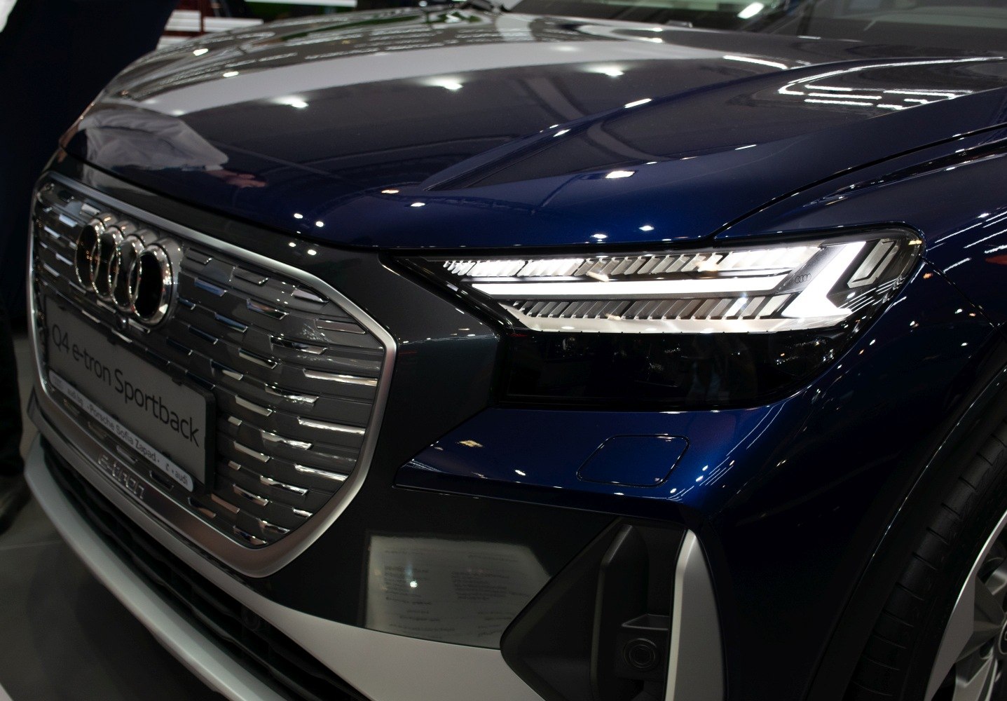 Close-up of front grille and LED headlights with sleek design and lighting detail