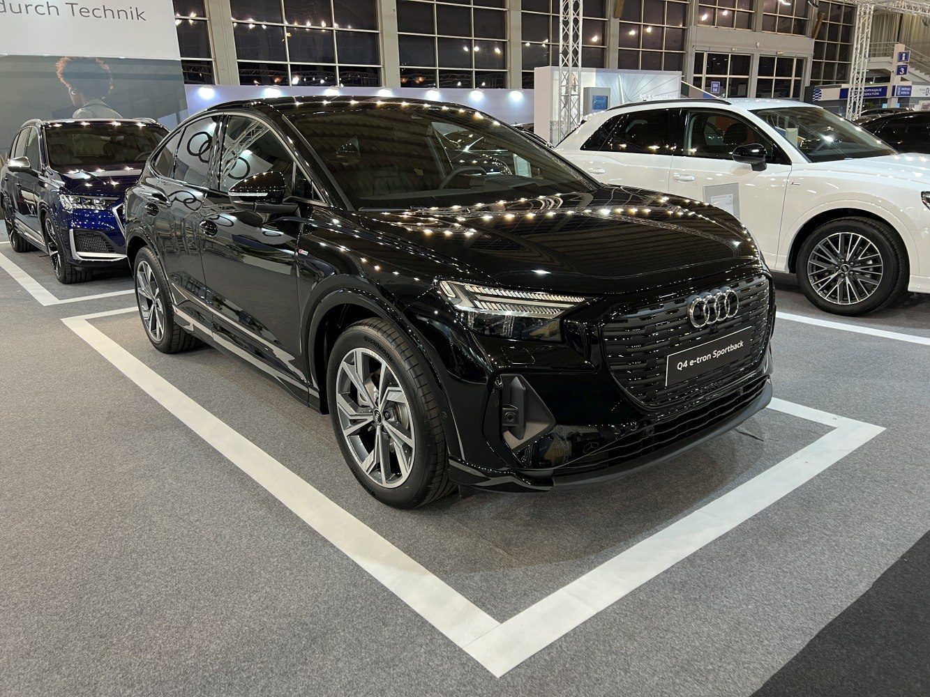 Black electric SUV with LED headlights and modern front design