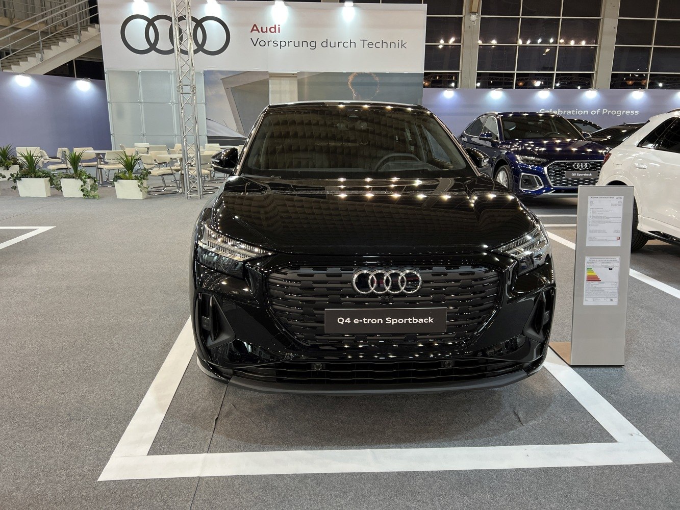 Front view of a sleek electric SUV with LED headlights and bold grille