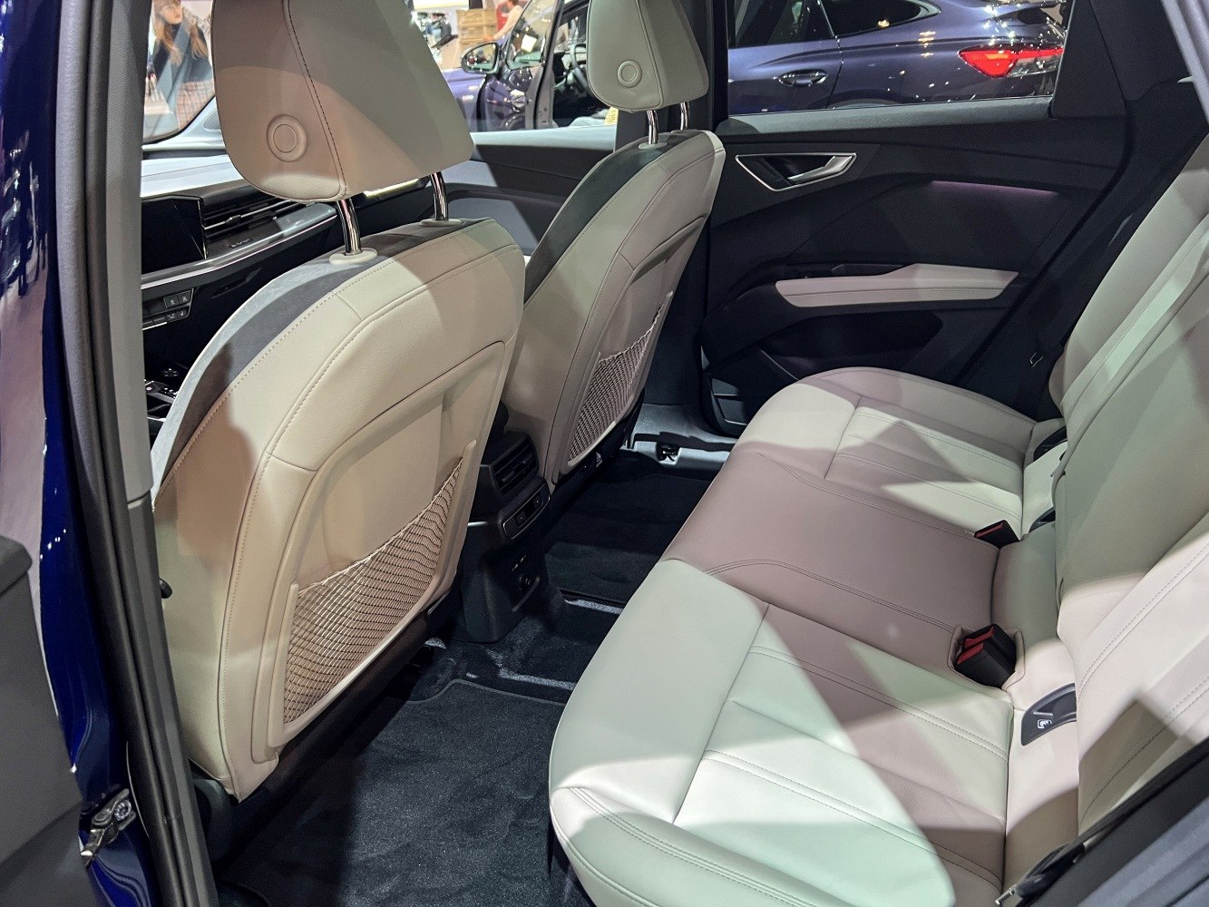 Rear passenger seat area with leather upholstery in a modern vehicle interior