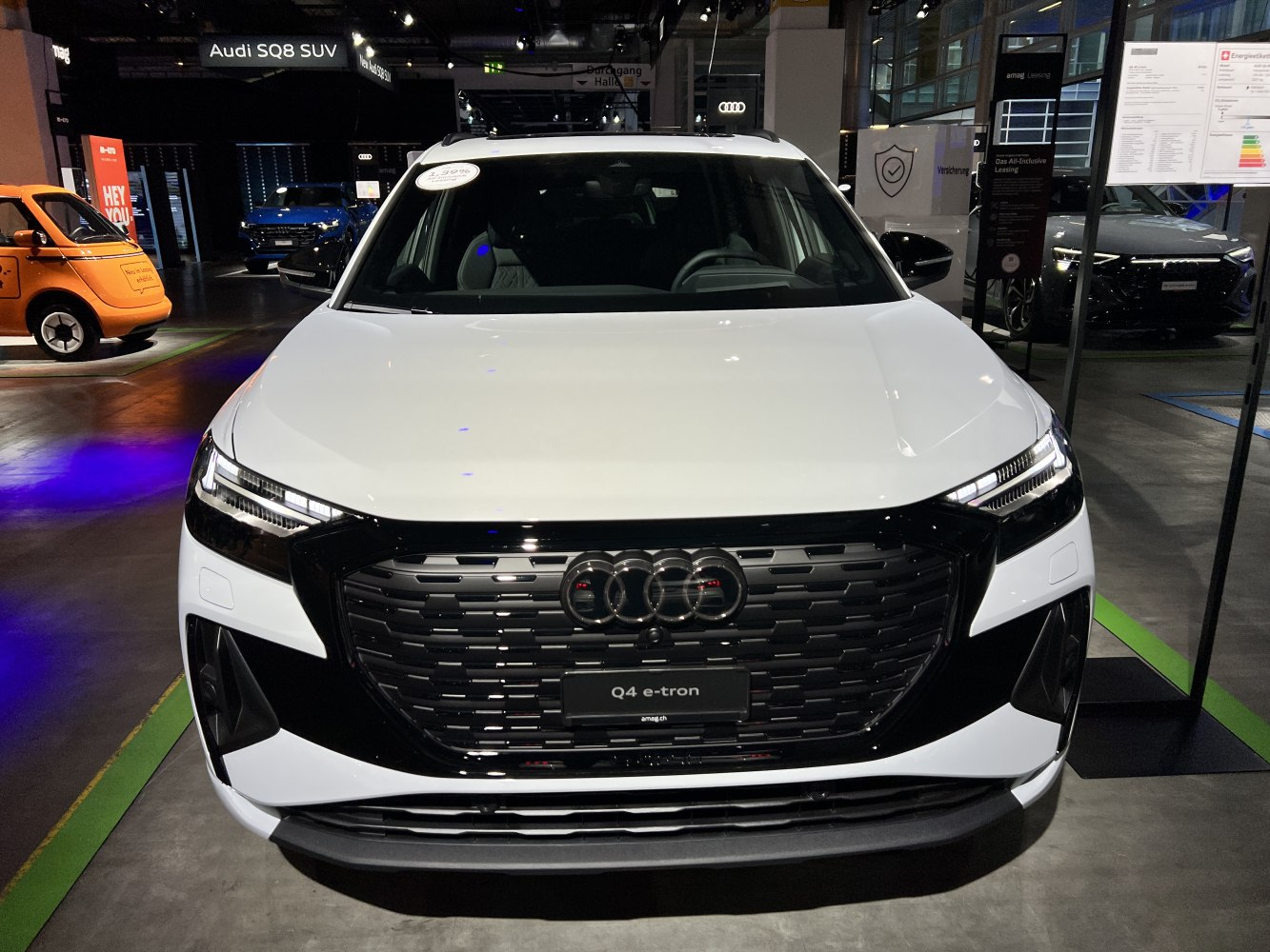 Front view with bold grille and LED headlights of a modern electric SUV