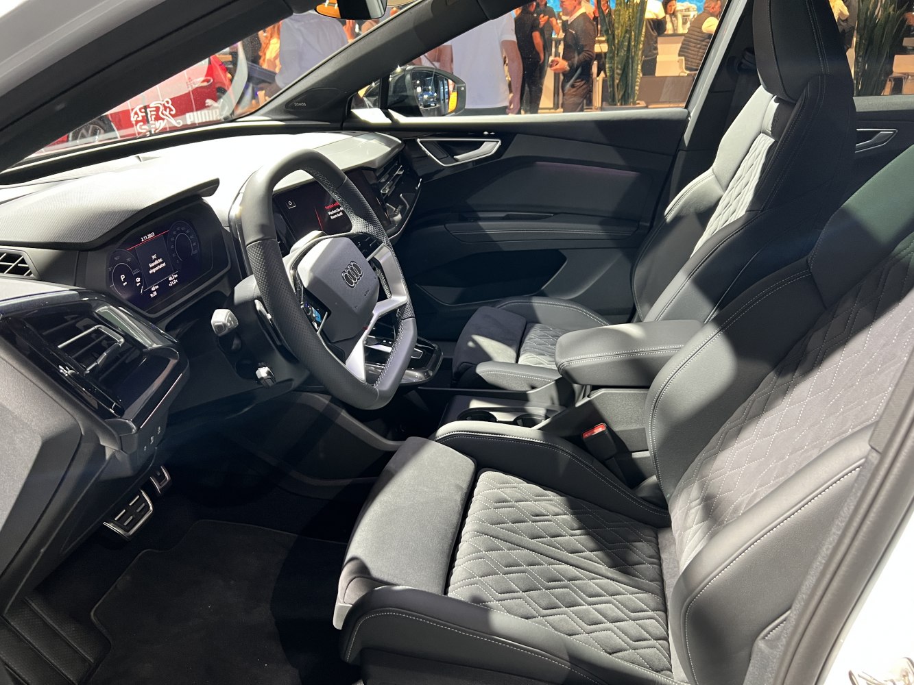 Diamond-stitched seats and digital instrument cluster inside a modern car interior