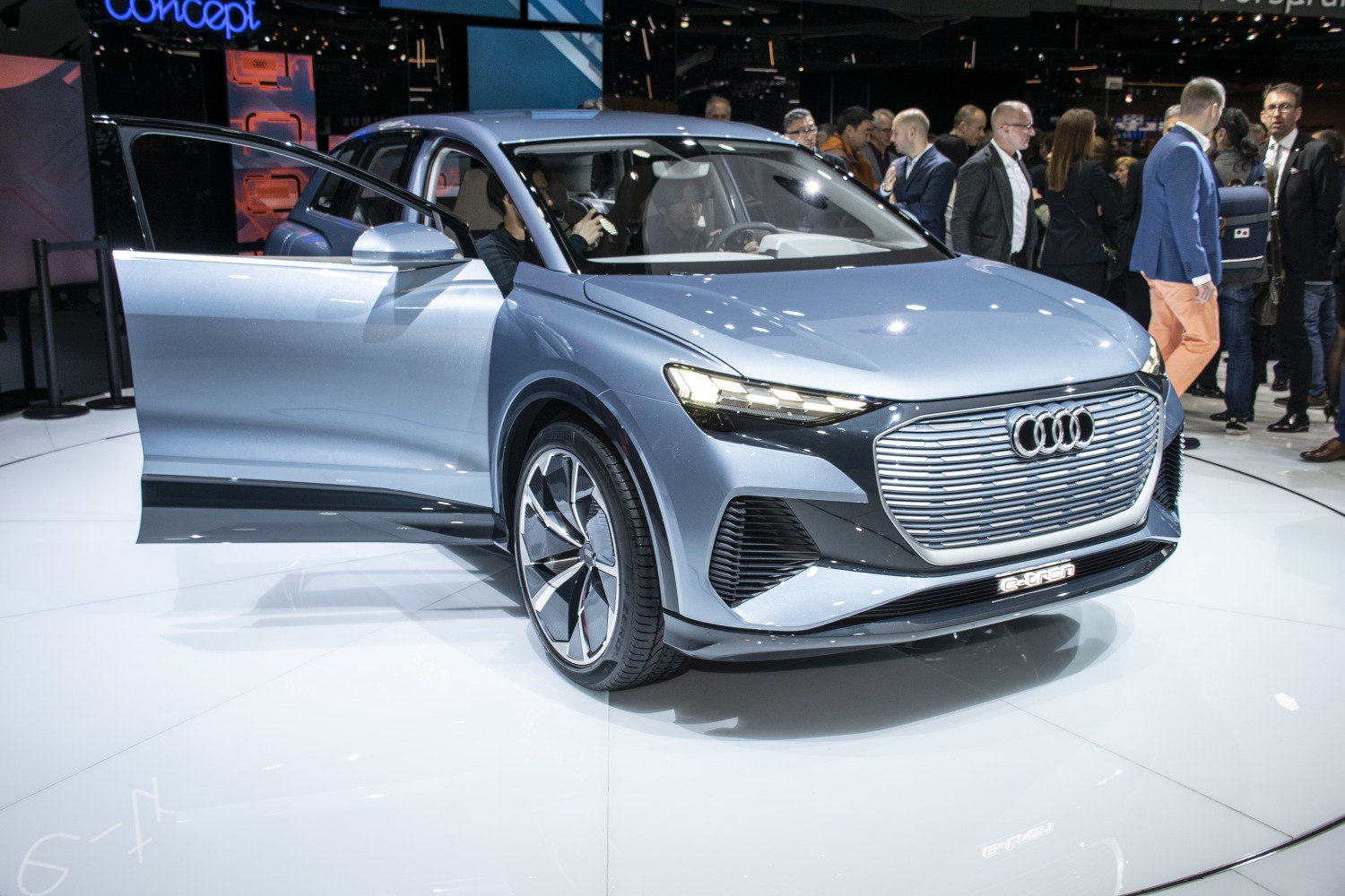 Front three-quarter view with open driver door of an electric SUV concept