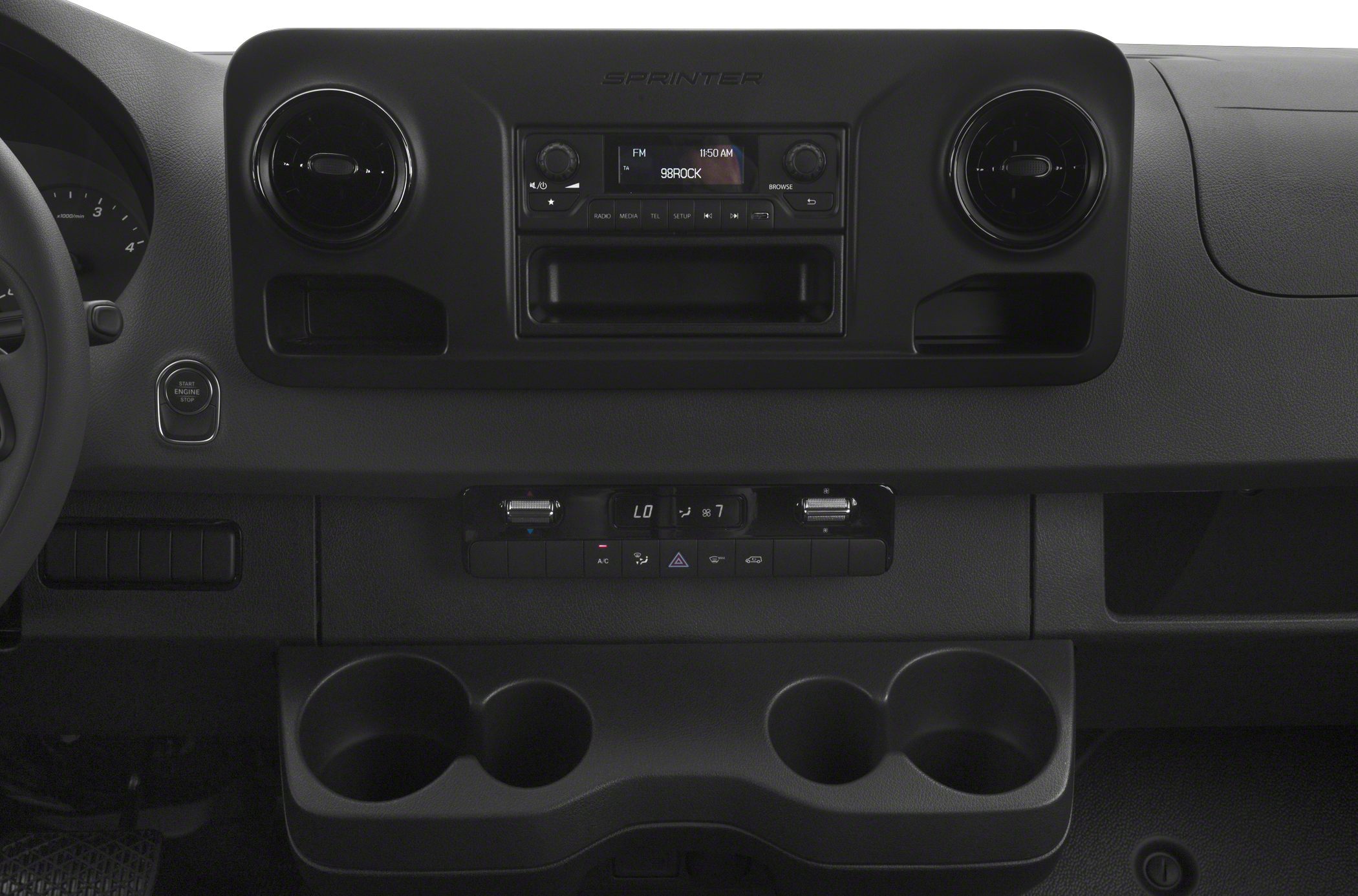Dashboard with circular air vents, radio, climate control, and cup holders
