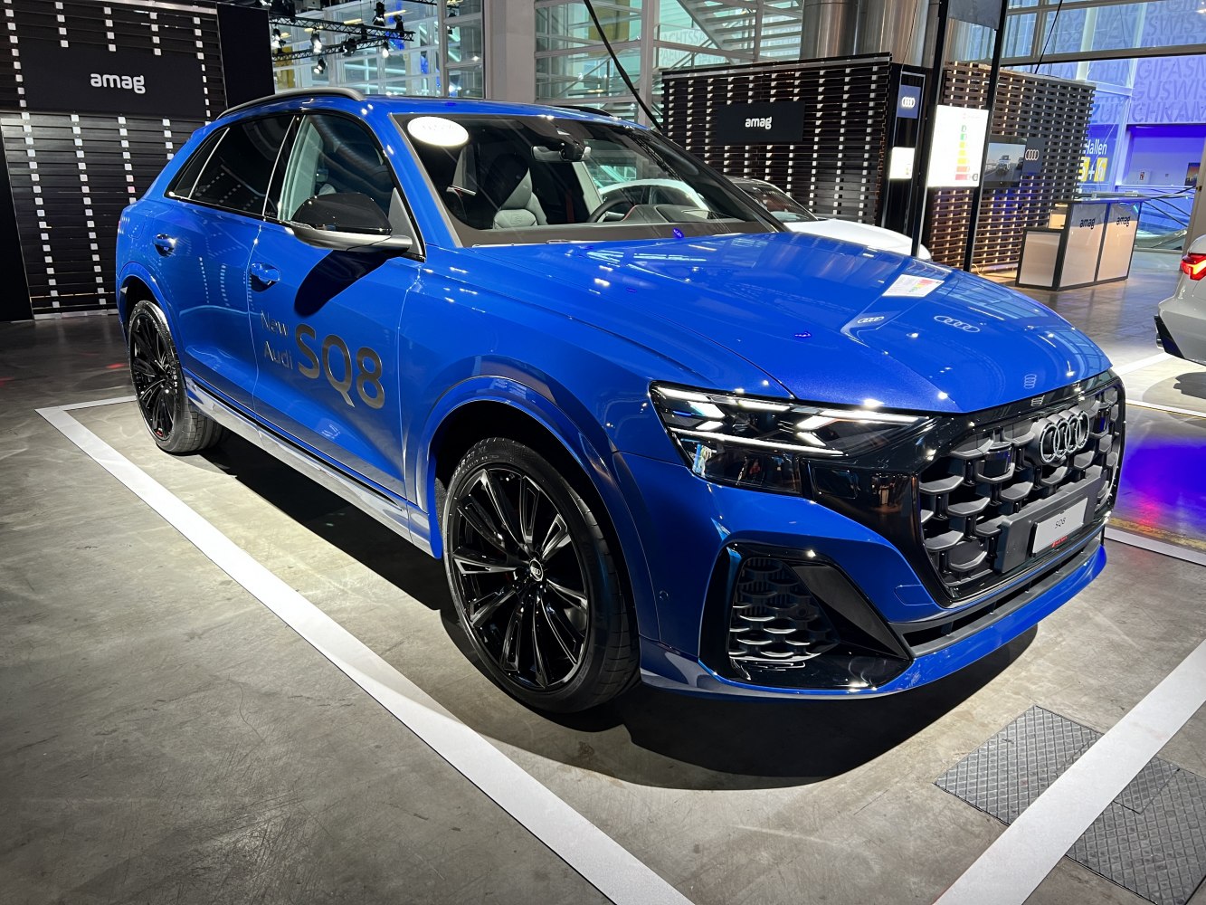 Aggressive front grille, LED headlights, black alloy wheels, blue SUV