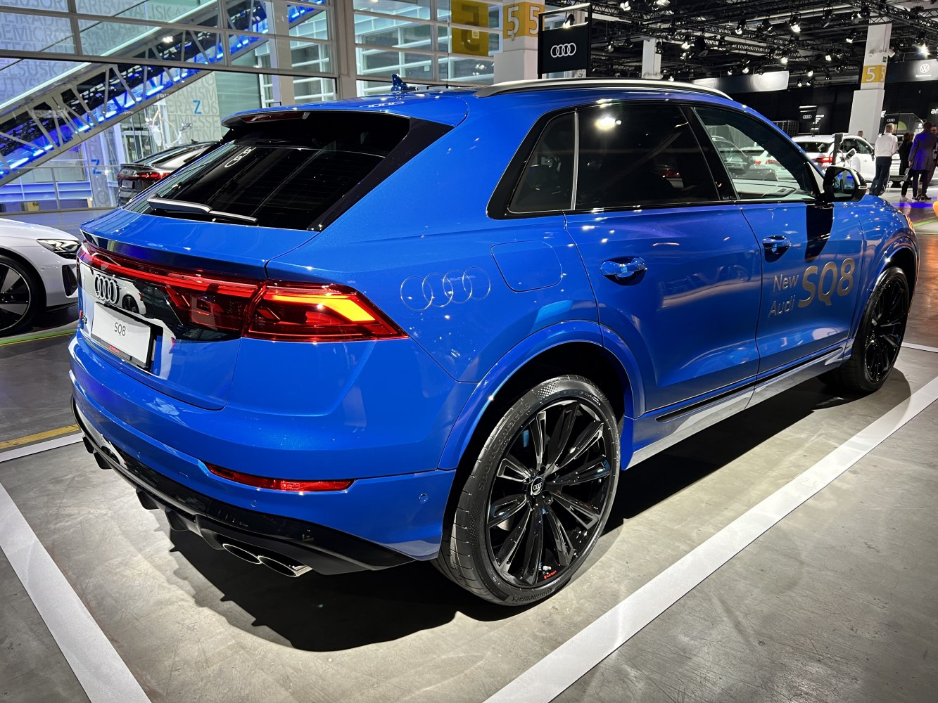 Rear side view of a sporty SUV with black alloy wheels and sleek taillights.