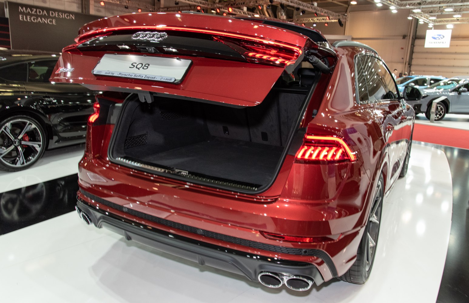 Rear view with open trunk, LED taillights, and quad exhaust pipes