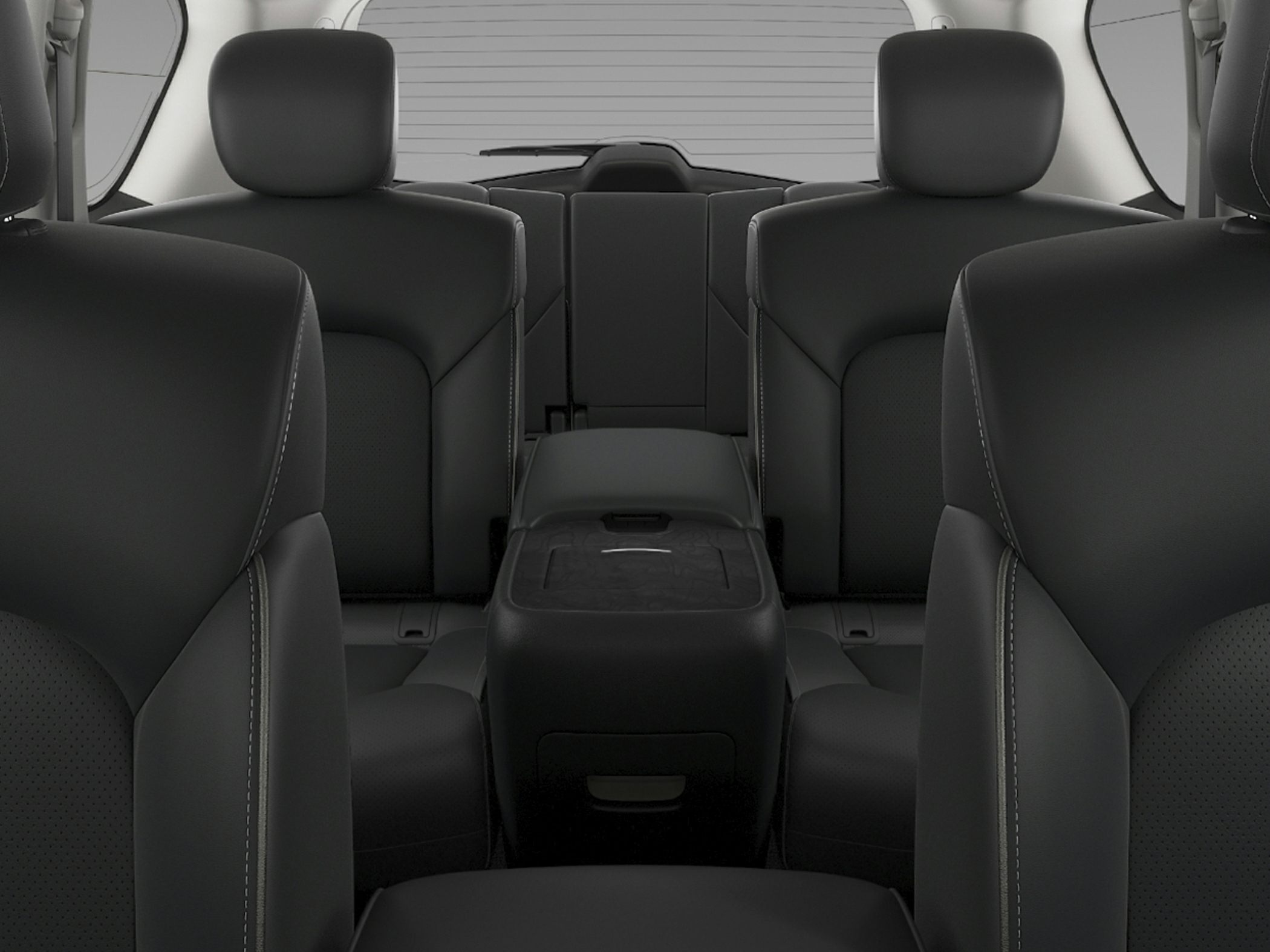 Black leather seats with detailed stitching and spacious interior seating arrangement