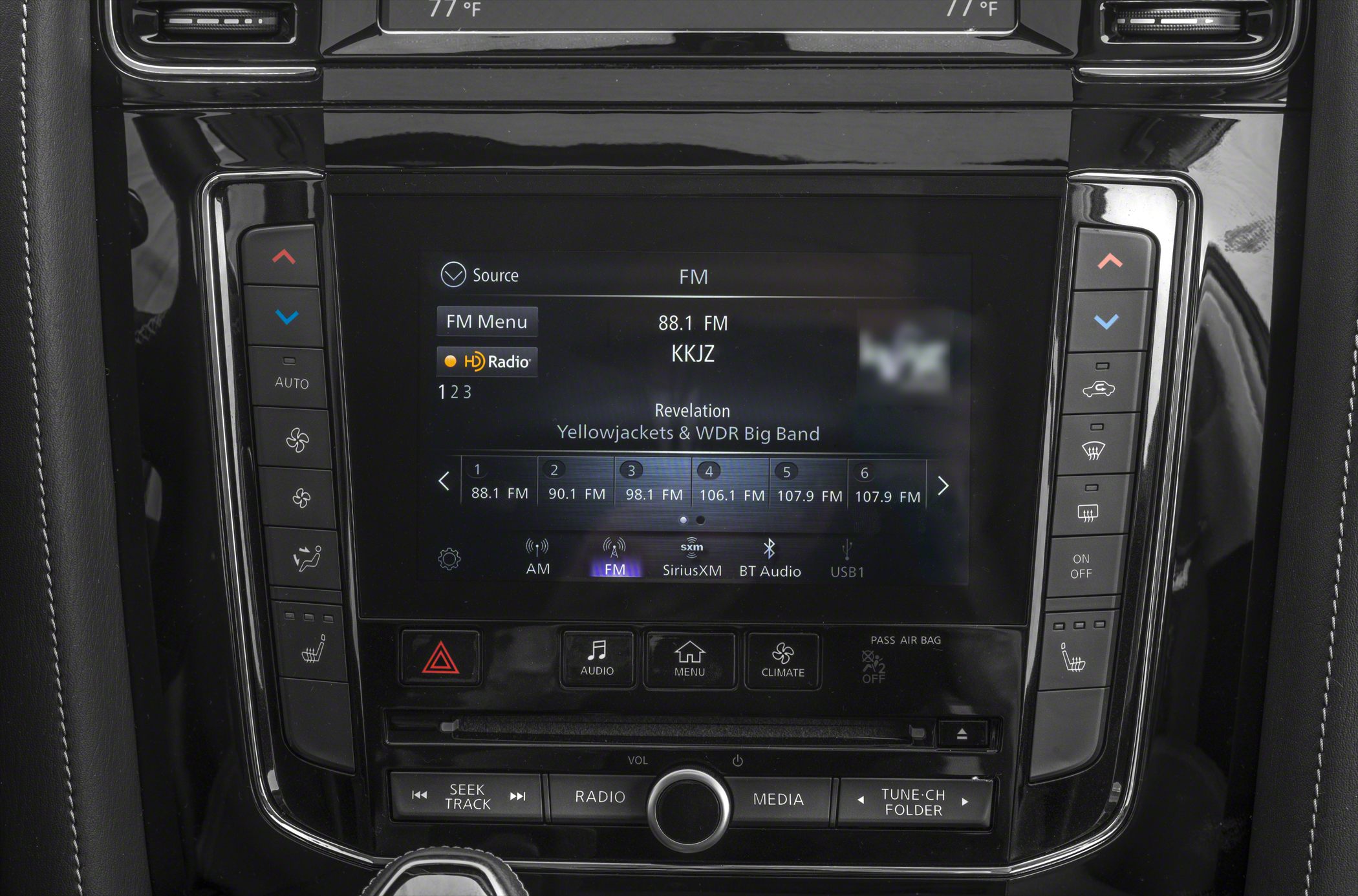 Infotainment touchscreen with climate and audio controls in vehicle center console