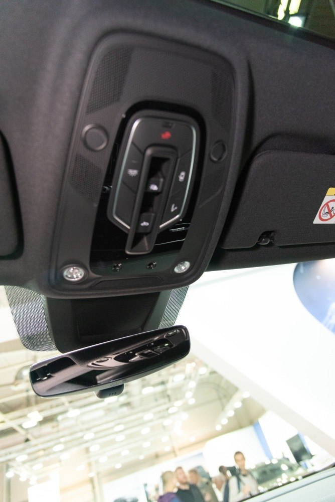 Interior roof console controls and rearview mirror in a luxury SUV.