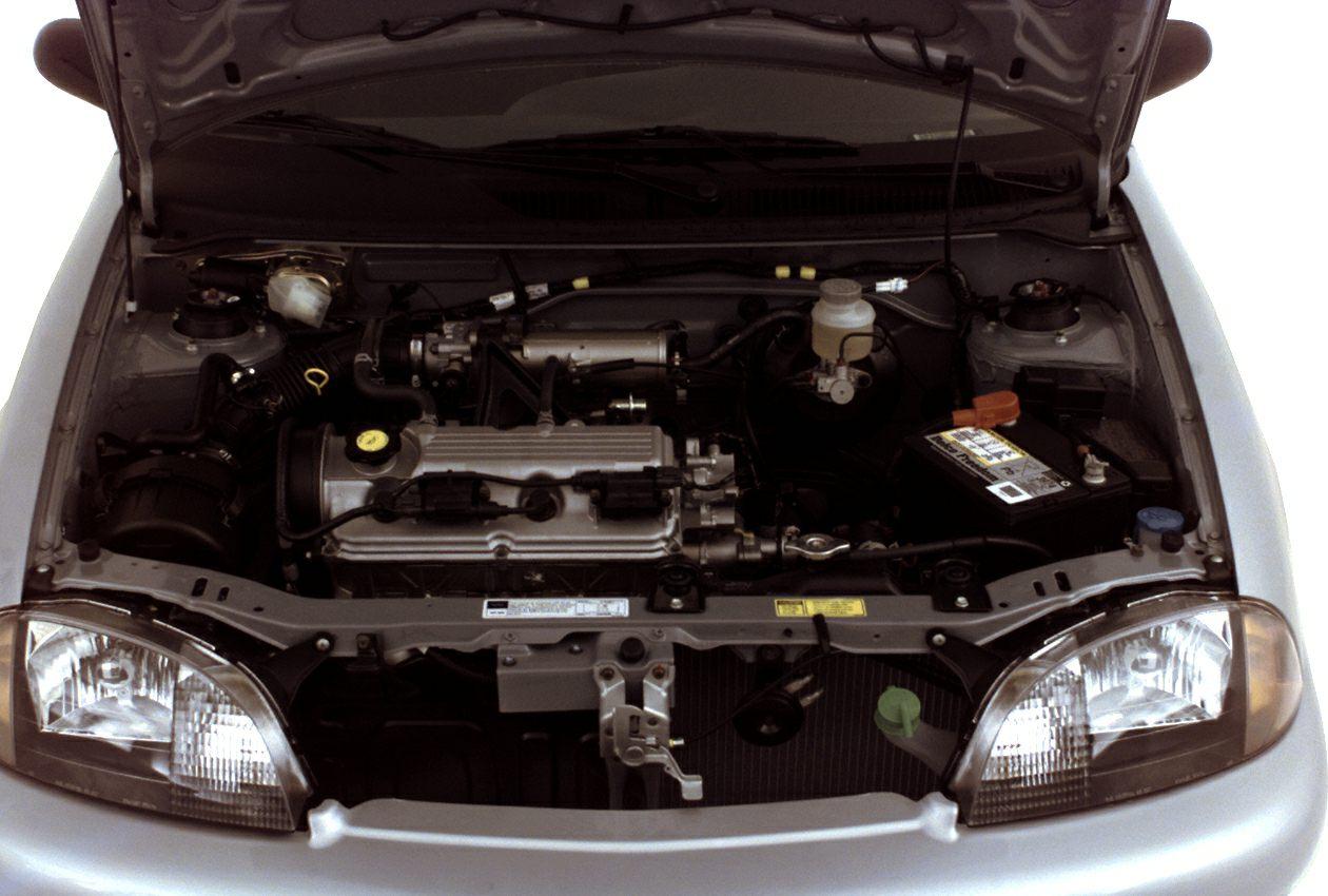 Open hood showing engine bay and front headlights.