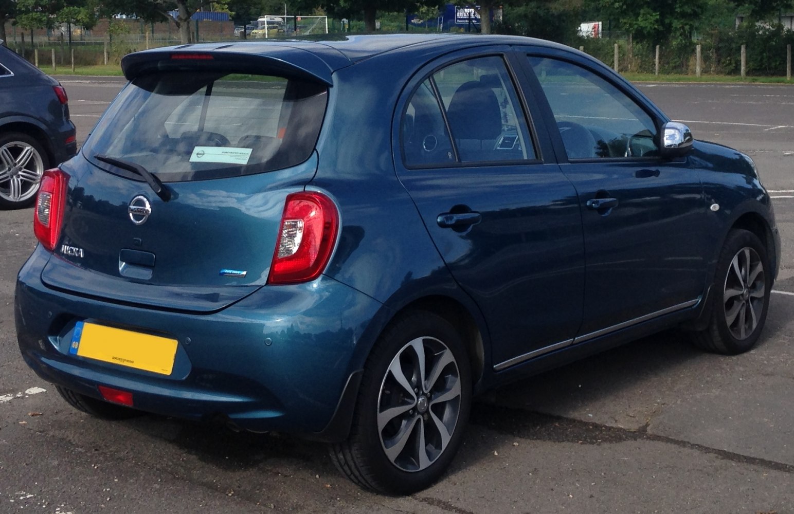 Rear-side profile of a compact hatchback with alloy wheels in blue