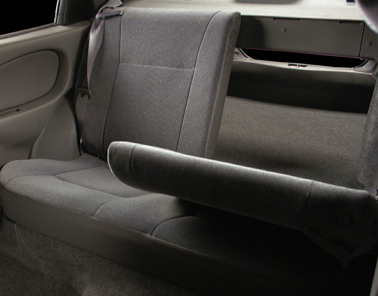 Rear foldable car seats with fabric upholstery in a compact sedan