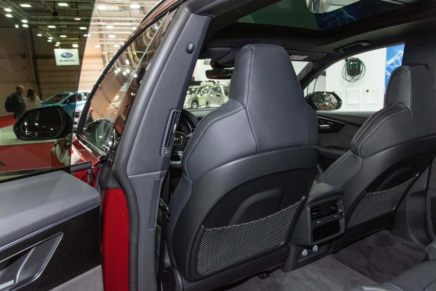 Rear seats and door panel with black leather and netted seatbacks