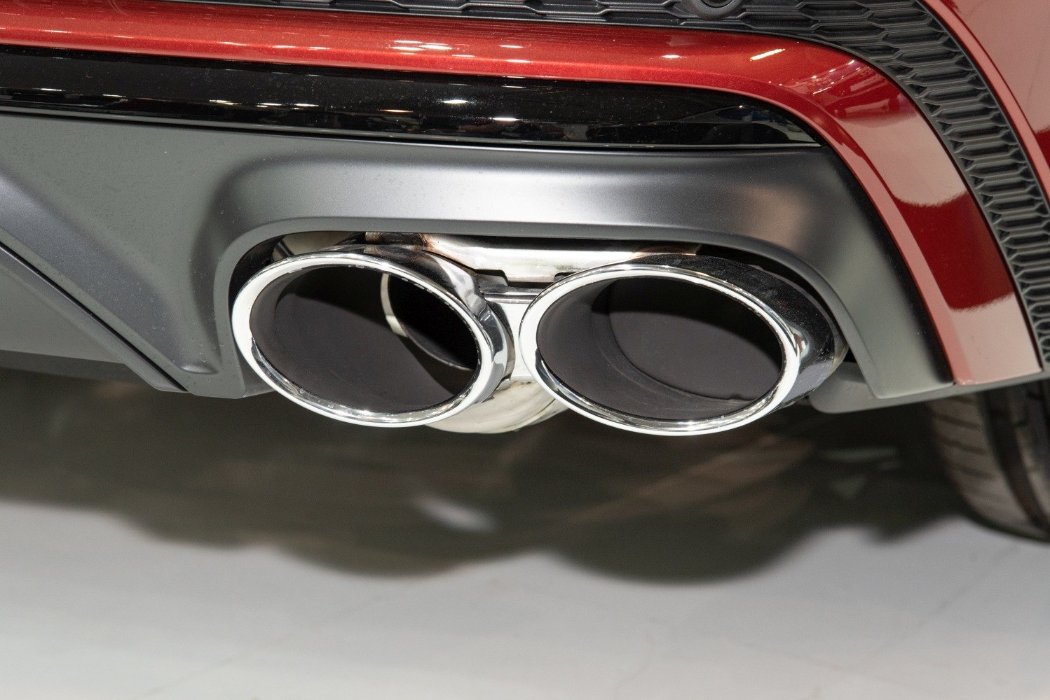 Dual oval stainless steel exhaust tips on a car rear